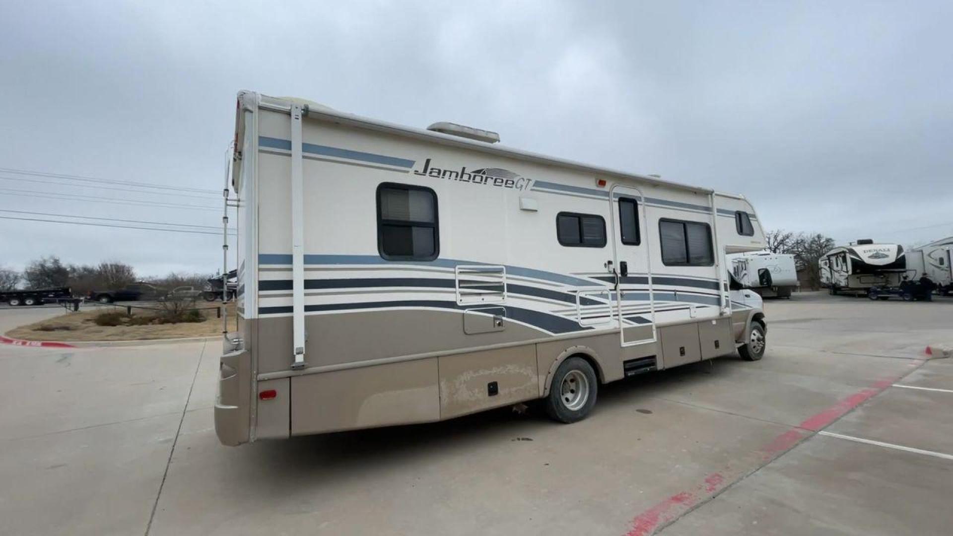 2003 WHITE FLEETWOOD JAMBOREE GT E450 (1FDXE45S93H) with an 6.8L V10 SOHC 20V engine, located at 4319 N Main St, Cleburne, TX, 76033, (817) 678-5133, 32.385960, -97.391212 - The 2003 Fleetwood Jamboree GT allows you to enjoy the beauty of nature. Experience the ultimate in RV luxury with rear roof access, providing unparalleled views from the comfort of your mobile abode. With a spacious awning and a slide-out feature, you'll have plenty of room to enjoy the outdoors an - Photo#1