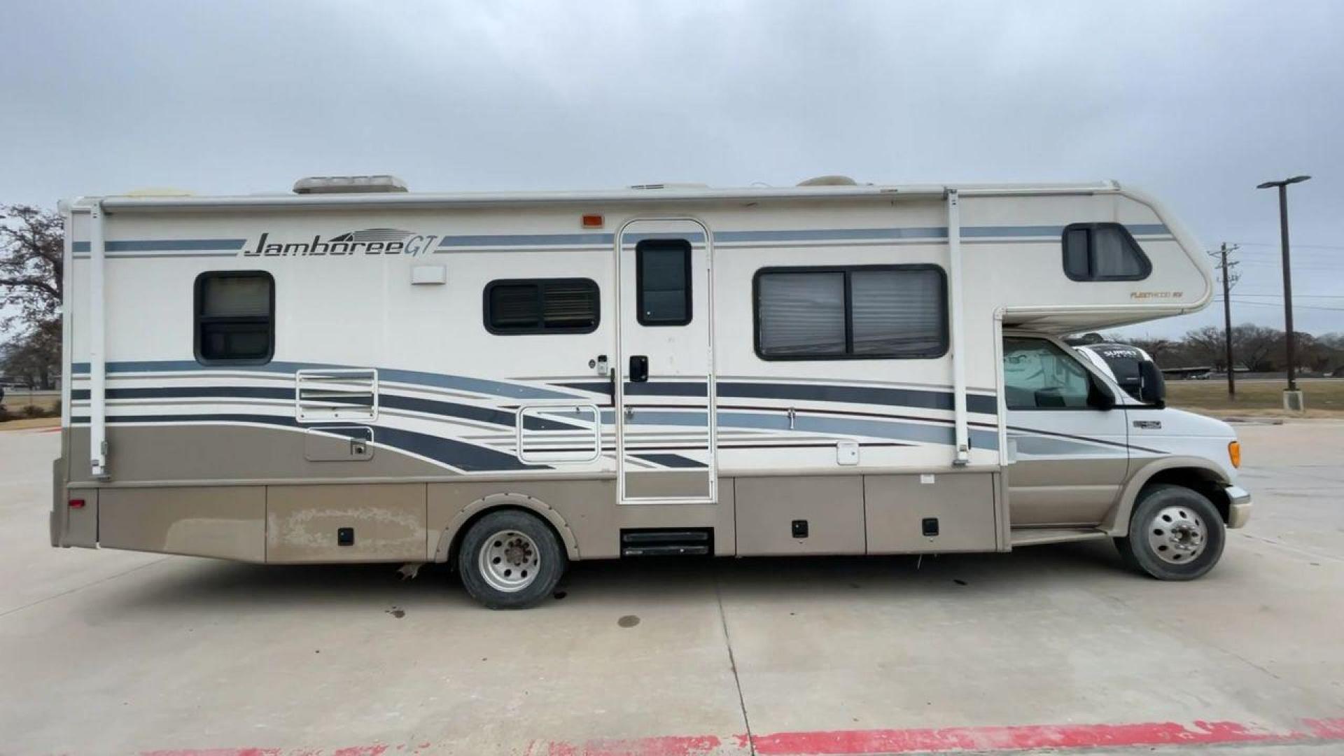 2003 WHITE FLEETWOOD JAMBOREE GT E450 (1FDXE45S93H) with an 6.8L V10 SOHC 20V engine, located at 4319 N Main St, Cleburne, TX, 76033, (817) 678-5133, 32.385960, -97.391212 - The 2003 Fleetwood Jamboree GT allows you to enjoy the beauty of nature. Experience the ultimate in RV luxury with rear roof access, providing unparalleled views from the comfort of your mobile abode. With a spacious awning and a slide-out feature, you'll have plenty of room to enjoy the outdoors an - Photo#2