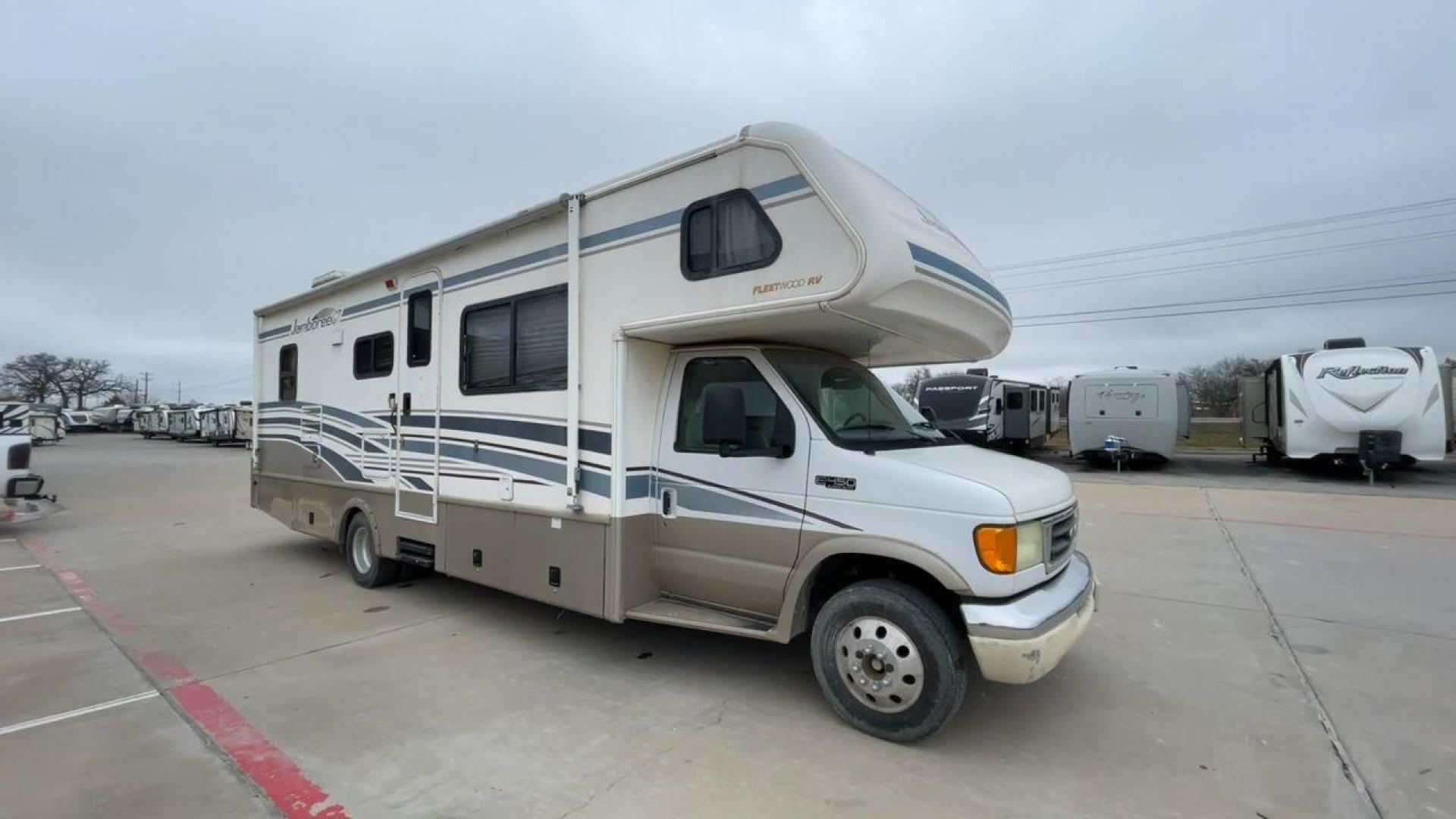 2003 WHITE FLEETWOOD JAMBOREE GT E450 (1FDXE45S93H) with an 6.8L V10 SOHC 20V engine, located at 4319 N Main St, Cleburne, TX, 76033, (817) 678-5133, 32.385960, -97.391212 - The 2003 Fleetwood Jamboree GT allows you to enjoy the beauty of nature. Experience the ultimate in RV luxury with rear roof access, providing unparalleled views from the comfort of your mobile abode. With a spacious awning and a slide-out feature, you'll have plenty of room to enjoy the outdoors an - Photo#3