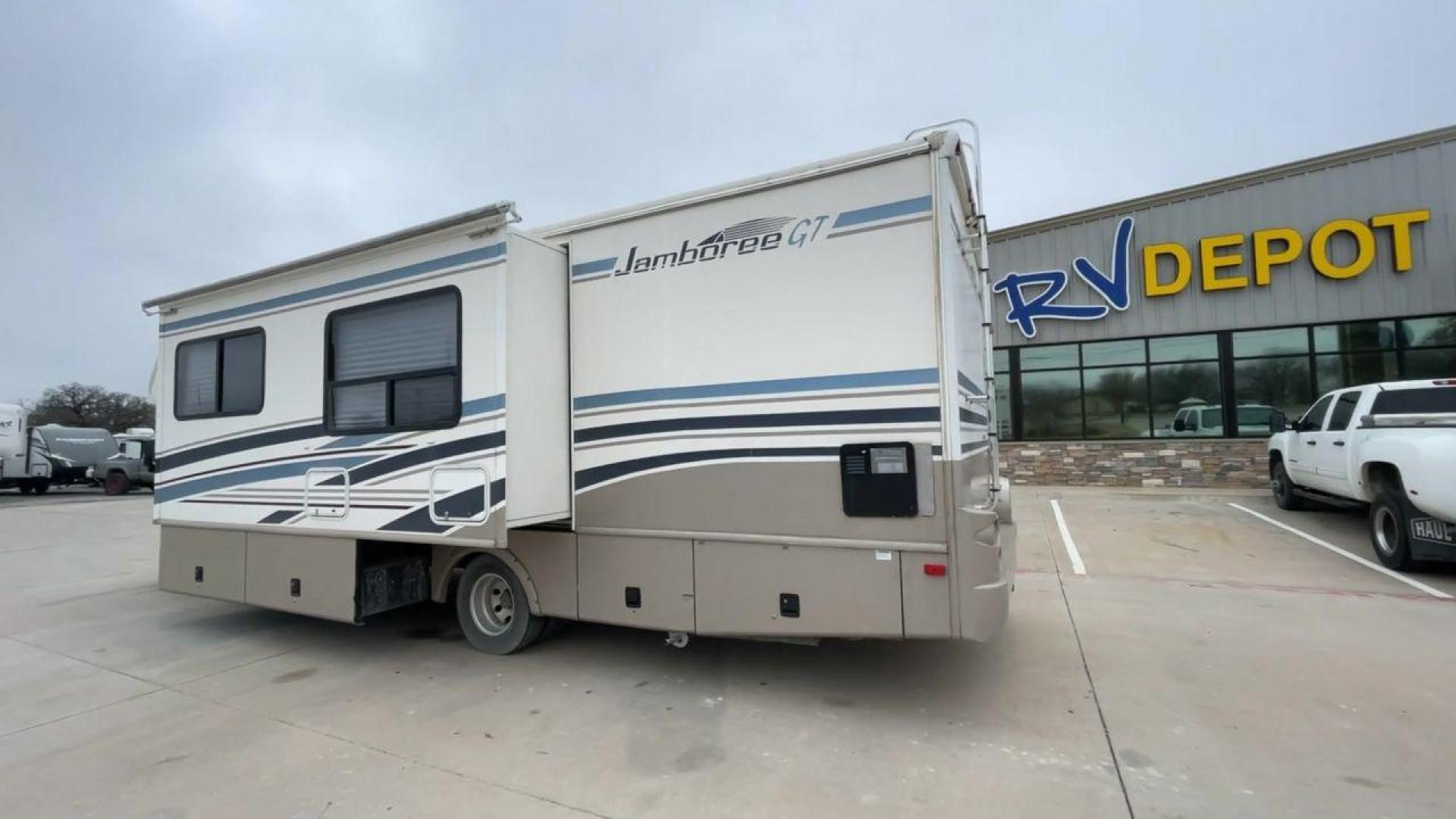 2003 WHITE FLEETWOOD JAMBOREE GT E450 (1FDXE45S93H) with an 6.8L V10 SOHC 20V engine, located at 4319 N Main St, Cleburne, TX, 76033, (817) 678-5133, 32.385960, -97.391212 - The 2003 Fleetwood Jamboree GT allows you to enjoy the beauty of nature. Experience the ultimate in RV luxury with rear roof access, providing unparalleled views from the comfort of your mobile abode. With a spacious awning and a slide-out feature, you'll have plenty of room to enjoy the outdoors an - Photo#7