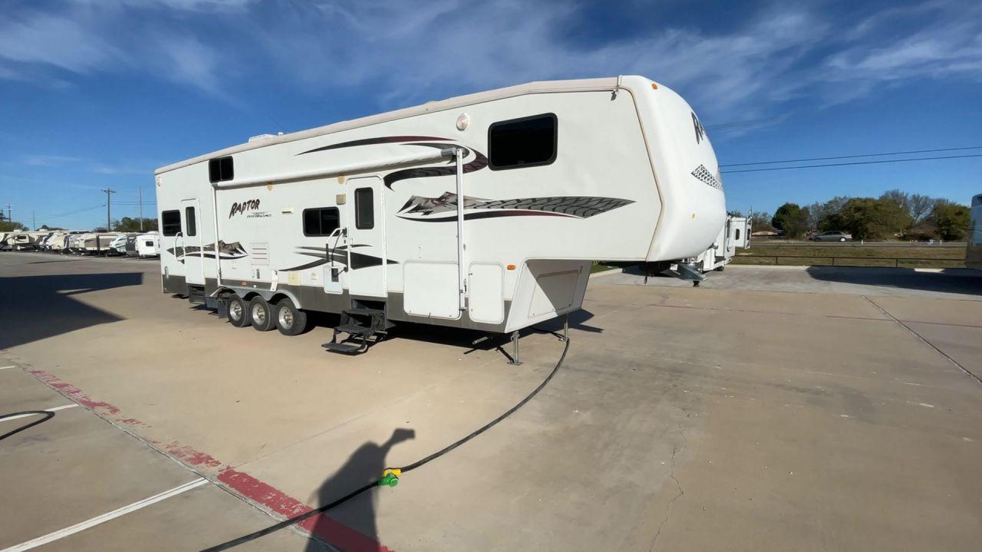 2006 KEYSTONE RAPTOR (4YDF361376M) , Length: 37.58 ft | Dry Weight: 11,615 lbs | Slides: 2 transmission, located at 4319 N Main St, Cleburne, TX, 76033, (817) 678-5133, 32.385960, -97.391212 - The 2016 Keystone Raptor RP3612 is a fifth-wheel toy hauler with a bold and functional exterior. It features a white body with stylish decals that include swooping lines and mountain graphics, giving it a sporty and adventurous look. The RV has three axles, offering stability and support for its lar - Photo#3