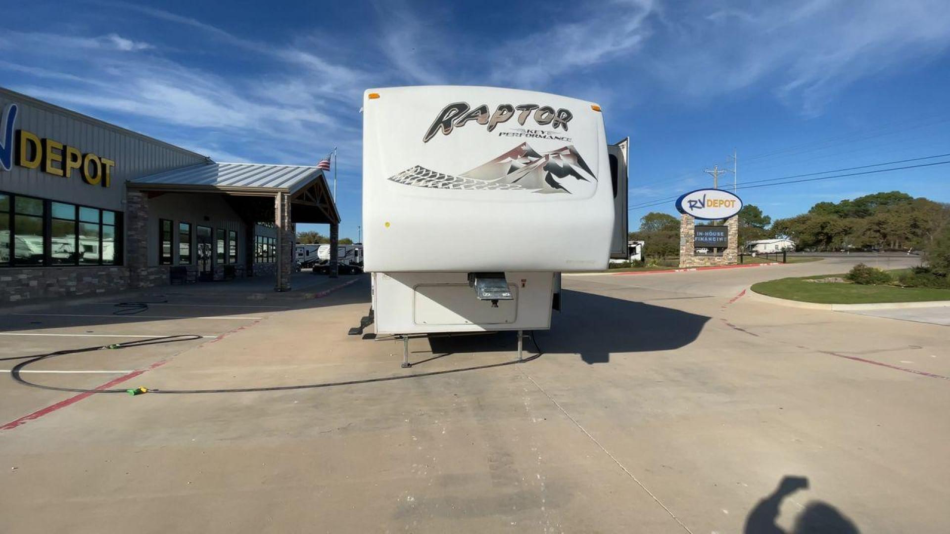 2006 KEYSTONE RAPTOR (4YDF361376M) , Length: 37.58 ft | Dry Weight: 11,615 lbs | Slides: 2 transmission, located at 4319 N Main St, Cleburne, TX, 76033, (817) 678-5133, 32.385960, -97.391212 - The 2016 Keystone Raptor RP3612 is a fifth-wheel toy hauler with a bold and functional exterior. It features a white body with stylish decals that include swooping lines and mountain graphics, giving it a sporty and adventurous look. The RV has three axles, offering stability and support for its lar - Photo#4