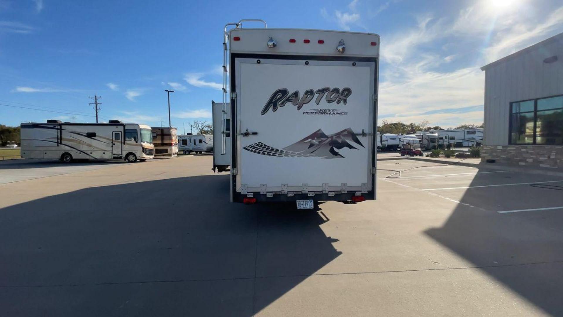 2006 KEYSTONE RAPTOR (4YDF361376M) , Length: 37.58 ft | Dry Weight: 11,615 lbs | Slides: 2 transmission, located at 4319 N Main St, Cleburne, TX, 76033, (817) 678-5133, 32.385960, -97.391212 - The 2016 Keystone Raptor RP3612 is a fifth-wheel toy hauler with a bold and functional exterior. It features a white body with stylish decals that include swooping lines and mountain graphics, giving it a sporty and adventurous look. The RV has three axles, offering stability and support for its lar - Photo#8