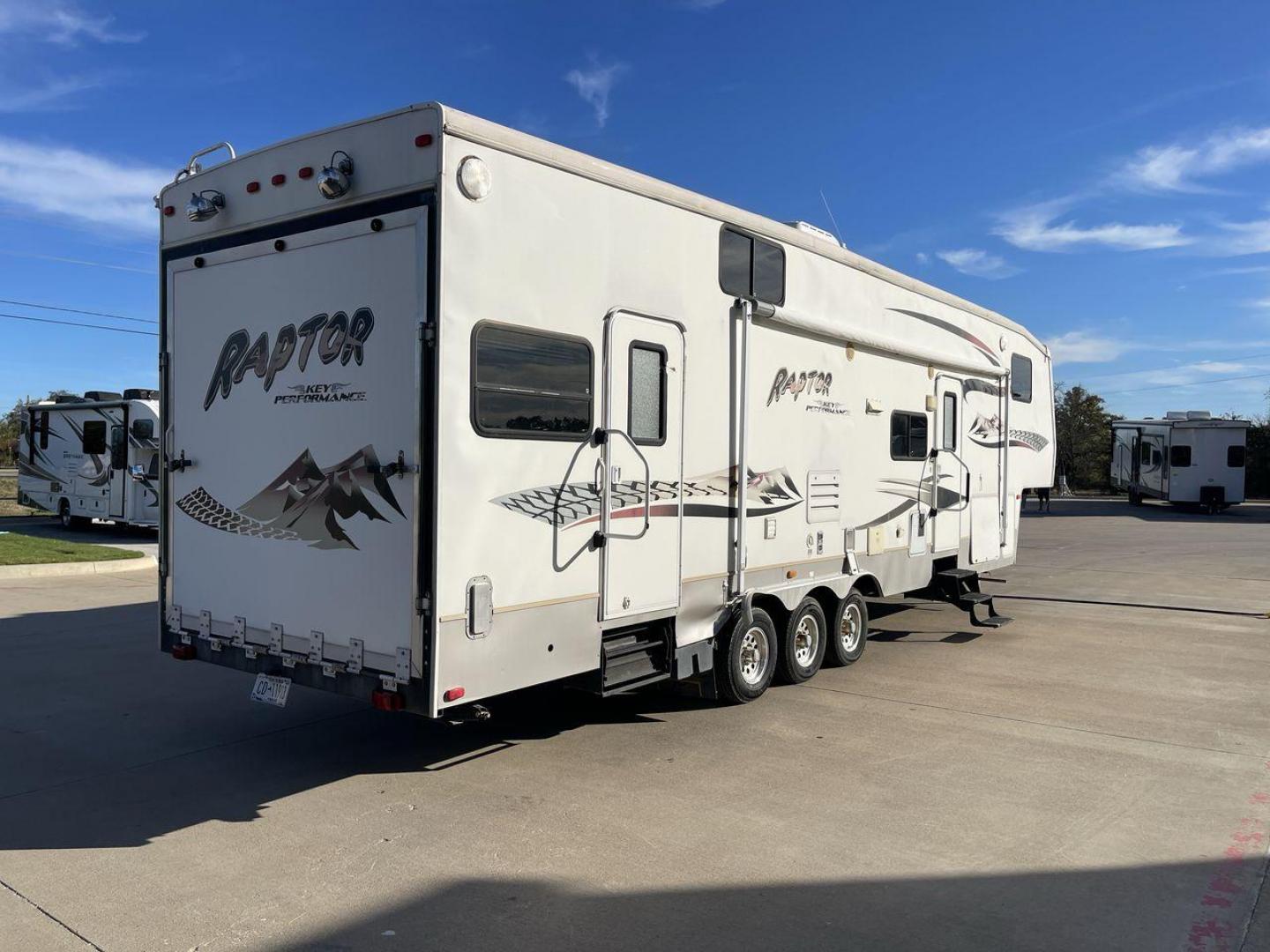 2006 KEYSTONE RAPTOR (4YDF361376M) , Length: 37.58 ft | Dry Weight: 11,615 lbs | Slides: 2 transmission, located at 4319 N Main St, Cleburne, TX, 76033, (817) 678-5133, 32.385960, -97.391212 - The 2016 Keystone Raptor RP3612 is a fifth-wheel toy hauler with a bold and functional exterior. It features a white body with stylish decals that include swooping lines and mountain graphics, giving it a sporty and adventurous look. The RV has three axles, offering stability and support for its lar - Photo#24