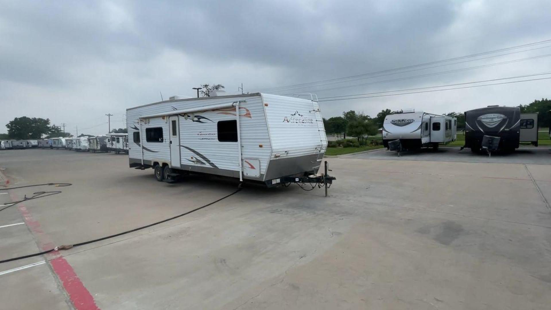 2008 WHITE ADRENALINE 23FS (1TC2B180683) , Length: 28.67 ft | Dry Weight: 6,474 lbs | Gross Weight: 9,500 lbs | Slides: 9 transmission, located at 4319 N Main St, Cleburne, TX, 76033, (817) 678-5133, 32.385960, -97.391212 - The 2008 Adrenaline 23FS Toy Hauler is prepared for a journey! It is 28.67 feet long and weighs 6,474 pounds when dry. It's lightweight and portable, but large enough to hold all of your favorite toys and accessories. It can accommodate up to 9,500 pounds, so you'll have plenty of room for your next - Photo#3