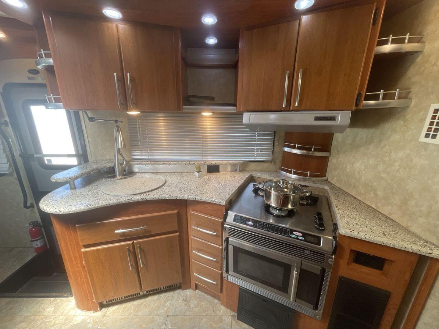 2008 TAN COACHMEN LEPRECHAUN 320DS E-450 (1FDXE45S08D) with an 6.8L V10 SOHC 20V engine, Length: 31.5 ft. | Dry Weight: 12,555 lbs. | Gross Weight: 14,500 lbs. | Slides: 2 transmission, located at 4319 N Main St, Cleburne, TX, 76033, (817) 678-5133, 32.385960, -97.391212 - The 2008 Coachmen Leprechaun 320DS is a Class C motorhome with a compact design of 31.5-foot length. It is designed to ease your travels without compromising on space or amenities. With a substantial dry weight of 12,555 lbs and a gross weight capacity of 14,500 lbs, it is built to handle all your t - Photo#10