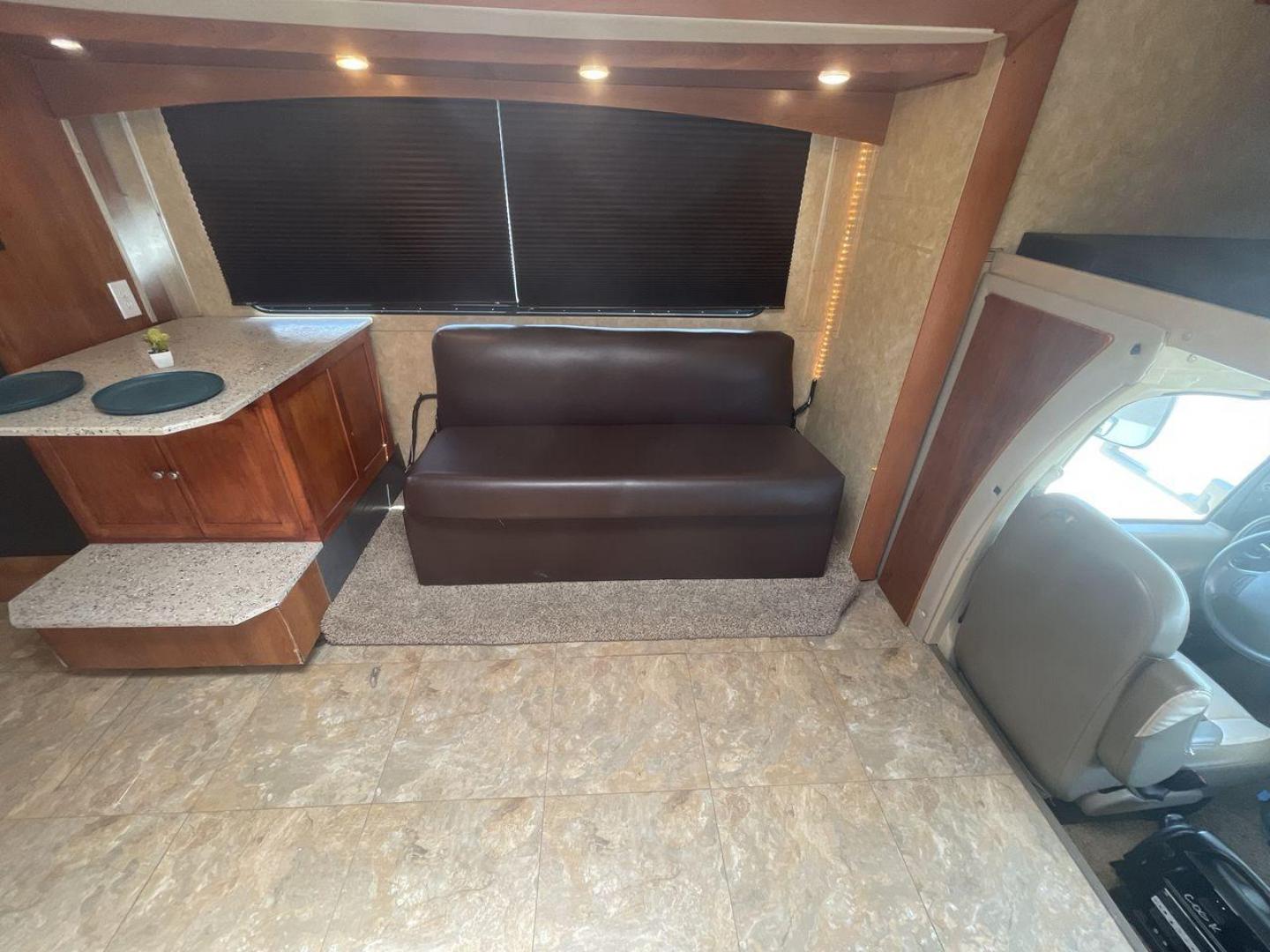 2008 TAN COACHMEN LEPRECHAUN 320DS E-450 (1FDXE45S08D) with an 6.8L V10 SOHC 20V engine, Length: 31.5 ft. | Dry Weight: 12,555 lbs. | Gross Weight: 14,500 lbs. | Slides: 2 transmission, located at 4319 N Main St, Cleburne, TX, 76033, (817) 678-5133, 32.385960, -97.391212 - The 2008 Coachmen Leprechaun 320DS is a Class C motorhome with a compact design of 31.5-foot length. It is designed to ease your travels without compromising on space or amenities. With a substantial dry weight of 12,555 lbs and a gross weight capacity of 14,500 lbs, it is built to handle all your t - Photo#12