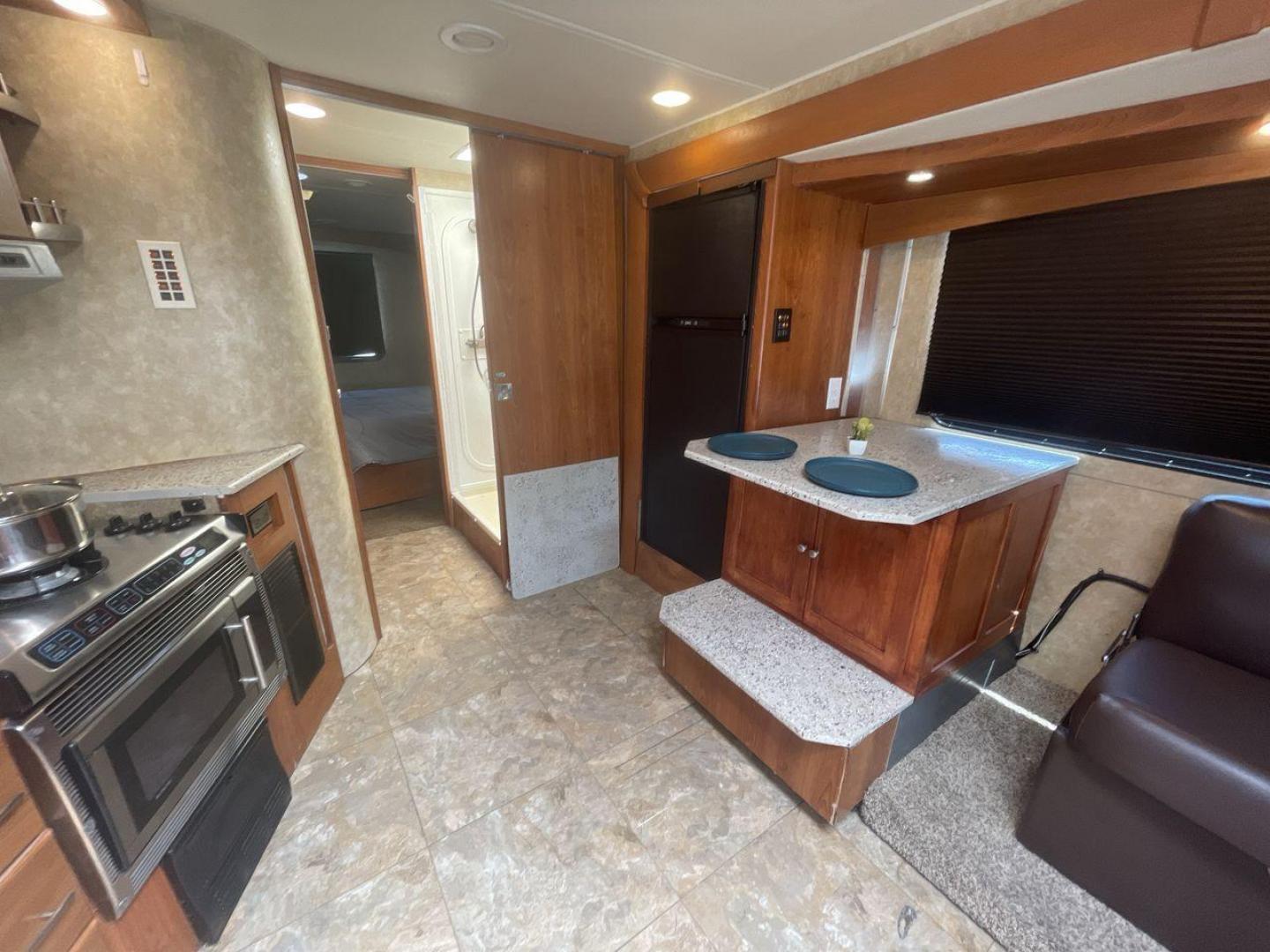 2008 TAN COACHMEN LEPRECHAUN 320DS E-450 (1FDXE45S08D) with an 6.8L V10 SOHC 20V engine, Length: 31.5 ft. | Dry Weight: 12,555 lbs. | Gross Weight: 14,500 lbs. | Slides: 2 transmission, located at 4319 N Main St, Cleburne, TX, 76033, (817) 678-5133, 32.385960, -97.391212 - The 2008 Coachmen Leprechaun 320DS is a Class C motorhome with a compact design of 31.5-foot length. It is designed to ease your travels without compromising on space or amenities. With a substantial dry weight of 12,555 lbs and a gross weight capacity of 14,500 lbs, it is built to handle all your t - Photo#13