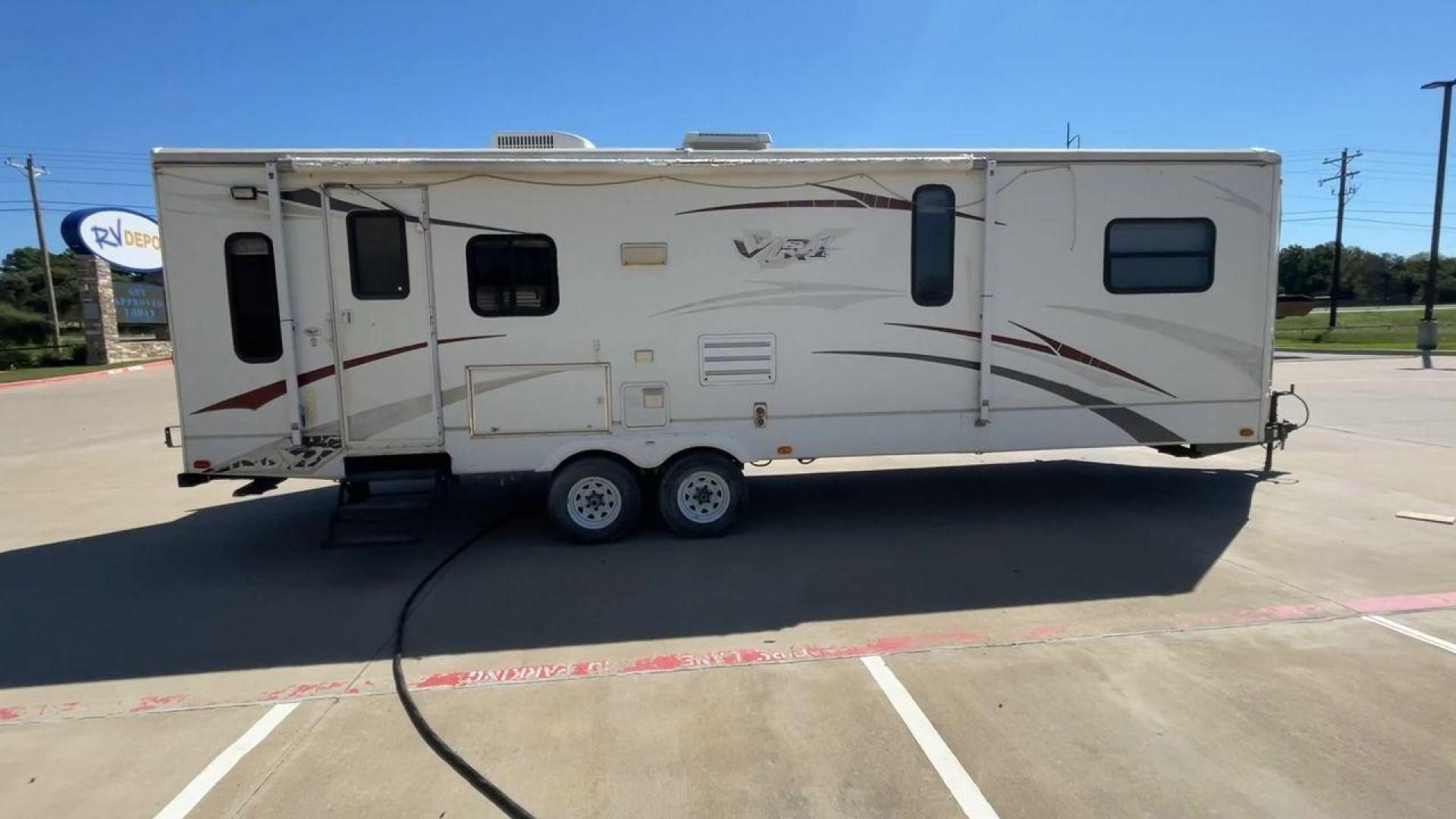 2008 WHITE VR-1 299RLS (4YDT299268V) , Length: 33 ft. | Dry Weight: 6,810 lbs. | Slides: 1 transmission, located at 4319 N Main St, Cleburne, TX, 76033, (817) 678-5133, 32.385960, -97.391212 - The 2008 VR-1 299RLS is a dual-axle steel wheel setup measuring 33 ft. long and 11.17 ft. tall. It has a dry weight of 6,810 lbs. and a payload capacity of 2,805 lbs. It also has a hitch weight of 815 lbs. It includes one slide and one power awning. This travel trailer features a rear living floorpl - Photo#2