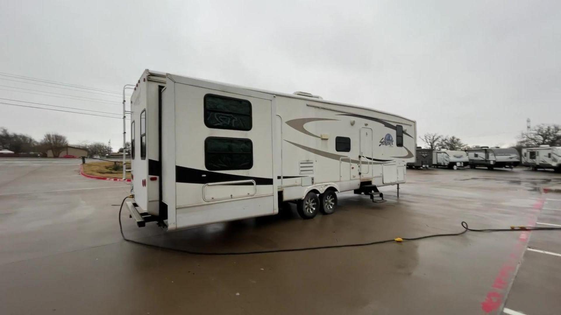 2010 WHITE CEDAR CREEK SILVERBA 35QB (4X4FCRL22AS) , Length: 41 ft.| Dry Weight: 12,184 lbs | Gross Weight: 15,500 lbs | Slides: 4 transmission, located at 4319 N Main St, Cleburne, TX, 76033, (817) 678-5133, 32.385960, -97.391212 - With a length of 39 feet, the 35QB floor plan offers a private bunkhouse at the rear, ensuring a cozy retreat for the little ones or a group of friends. Its spacious living area with slide-outs expands the interior space for comfortable dining and entertainment. The kitchen is equipped with resident - Photo#1