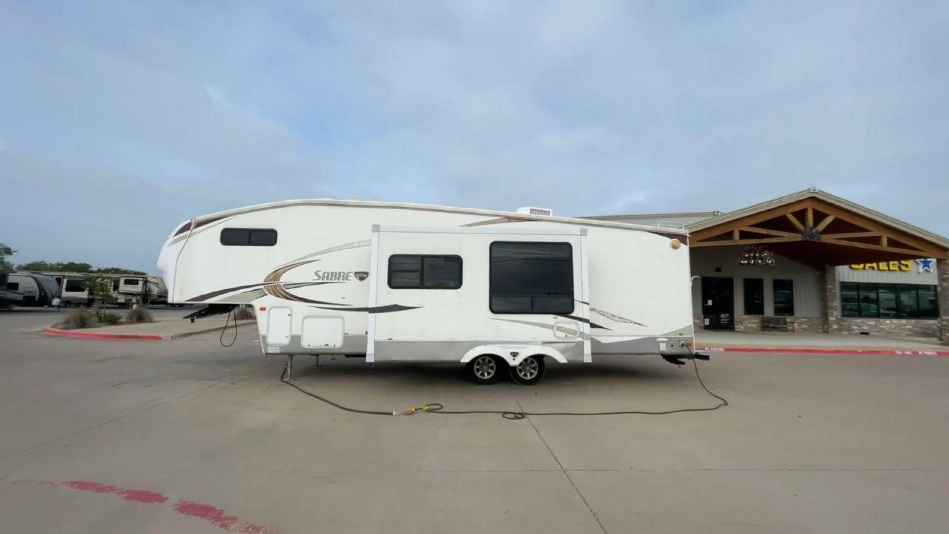 2010 WHITE FOREST RIVER SABRE 32QBDS - (4X4FSRH28A3) , Length: 35 ft. | Dry Weight: 9,235 lbs. | Gross Weight: 11,682 lbs. | Slides: 2 transmission, located at 4319 N Main St, Cleburne, TX, 76033, (817) 678-5133, 32.385960, -97.391212 - This 2010 Forest River Sabre 32QBDS has a very family-friendly floor plan. It measures 35 ft in length and has a dry weight of 9,235 lbs. The gross weight is 11,682 lbs, and it has two slides. The door leads you to the central living and kitchen area. The living area comes with an entertainment cent - Photo#6