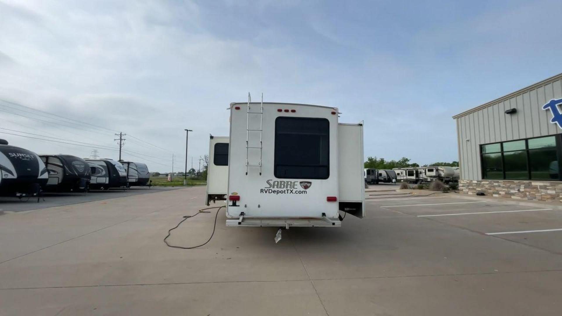 2010 WHITE FOREST RIVER SABRE 32QBDS - (4X4FSRH28A3) , Length: 35 ft. | Dry Weight: 9,235 lbs. | Gross Weight: 11,682 lbs. | Slides: 2 transmission, located at 4319 N Main St, Cleburne, TX, 76033, (817) 678-5133, 32.385960, -97.391212 - This 2010 Forest River Sabre 32QBDS has a very family-friendly floor plan. It measures 35 ft in length and has a dry weight of 9,235 lbs. The gross weight is 11,682 lbs, and it has two slides. The door leads you to the central living and kitchen area. The living area comes with an entertainment cent - Photo#8