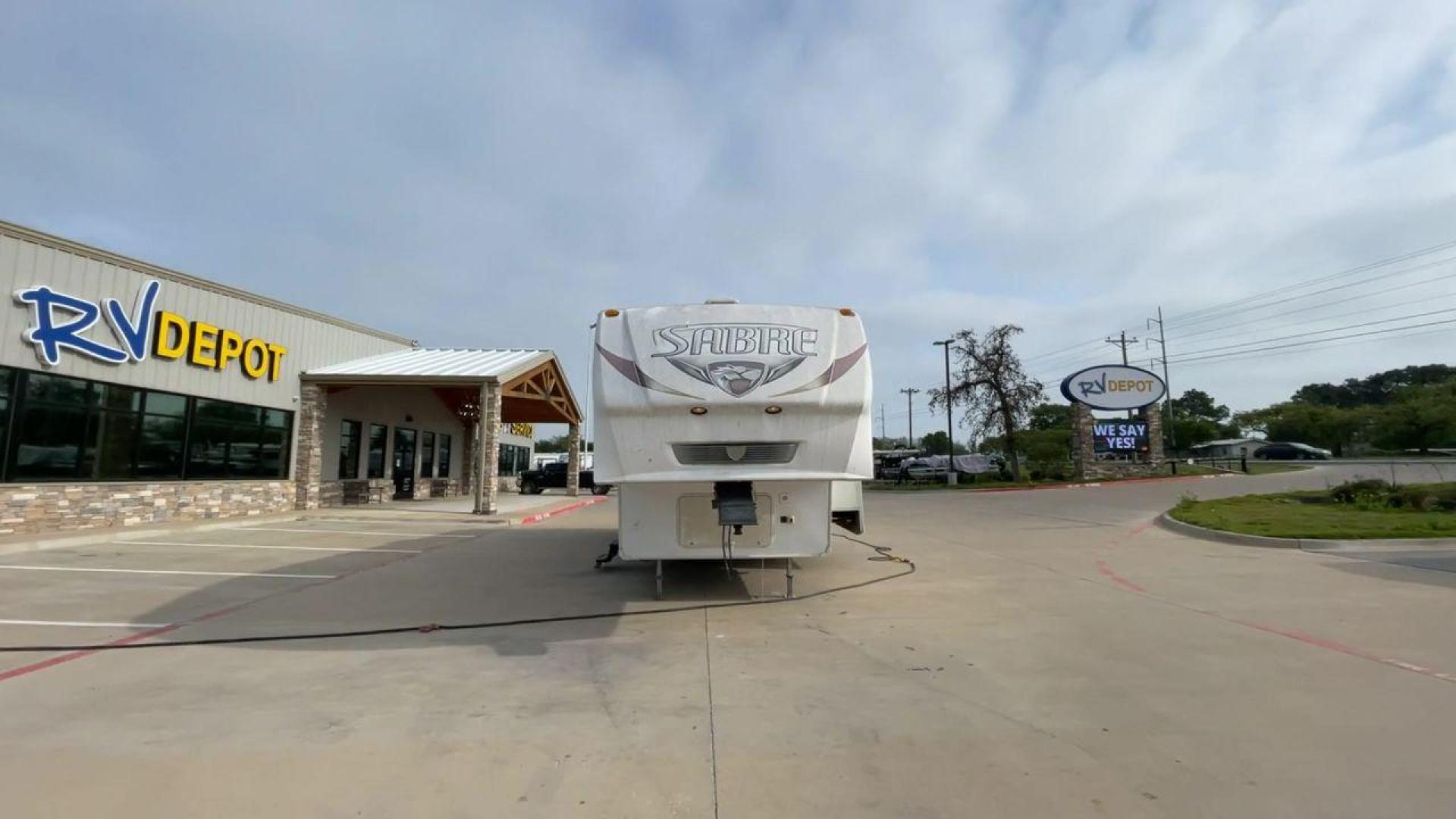 2010 WHITE FOREST RIVER SABRE 32QBDS - (4X4FSRH28A3) , Length: 35 ft. | Dry Weight: 9,235 lbs. | Gross Weight: 11,682 lbs. | Slides: 2 transmission, located at 4319 N Main St, Cleburne, TX, 76033, (817) 678-5133, 32.385960, -97.391212 - This 2010 Forest River Sabre 32QBDS has a very family-friendly floor plan. It measures 35 ft in length and has a dry weight of 9,235 lbs. The gross weight is 11,682 lbs, and it has two slides. The door leads you to the central living and kitchen area. The living area comes with an entertainment cent - Photo#4