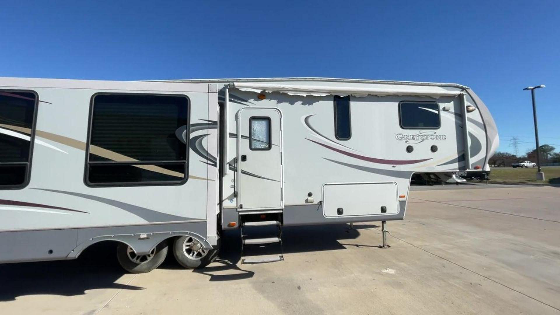 2011 WHITE HEARTLAND GREYSTONE 32RE (5SFSG3228BE) , Length: 34.83 ft. | Dry Weight: 10,421 lbs. | Gross Weight: 13,840 lbs. | Slides: 3 transmission, located at 4319 N Main St, Cleburne, TX, 76033, (817) 678-5133, 32.385960, -97.391212 - This 2011 Heartland Greystone 32RE is a dual-axle aluminum wheel setup measuring nearly 35 feet long. It has a dry weight of 10,421 lbs. and a GVWR of 13,840 lbs. It includes three power slides as well as one 16-foot power awning. This unit features a classic rear living and front bedroom floor plan - Photo#2