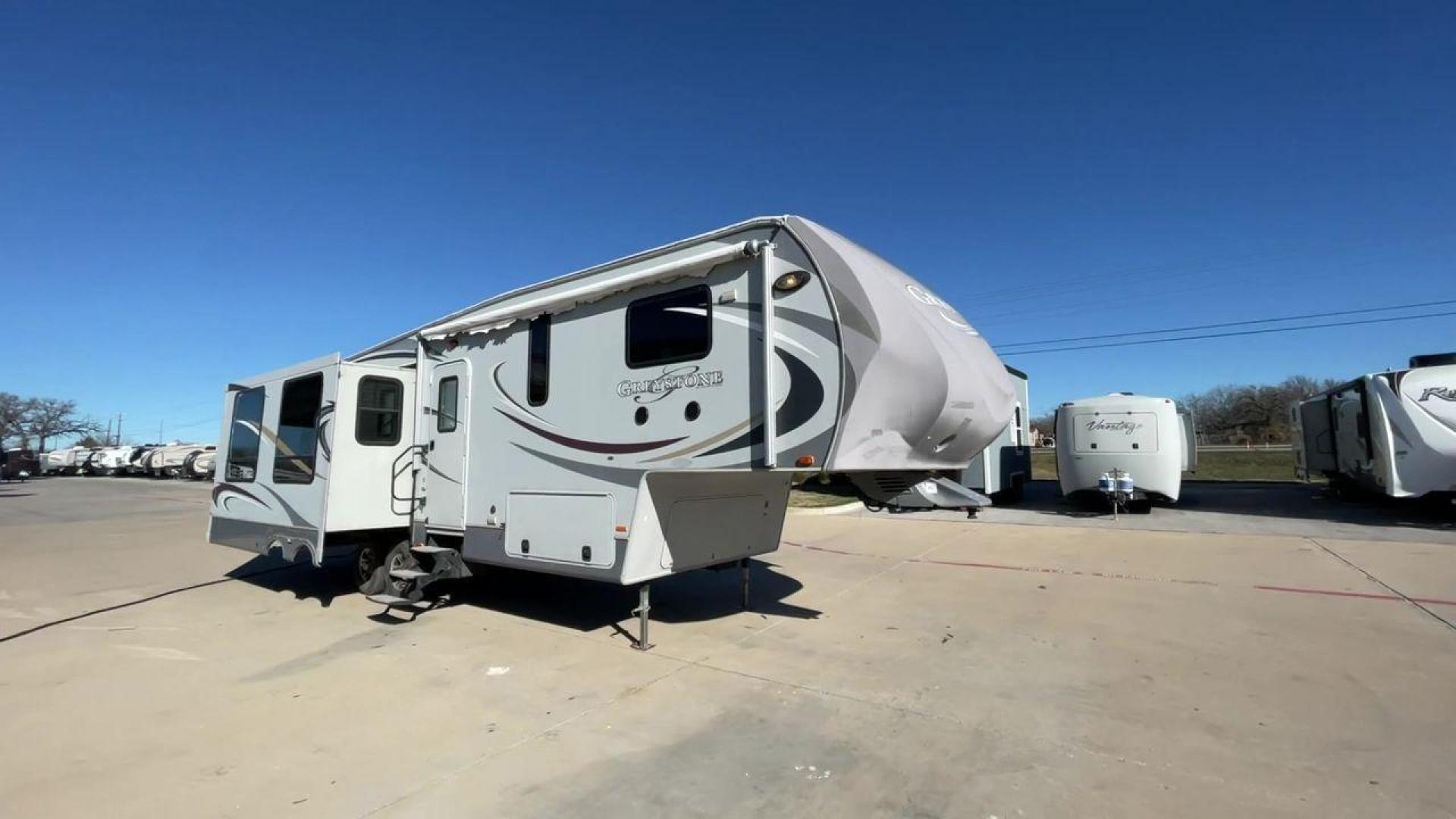 2011 WHITE HEARTLAND GREYSTONE 32RE (5SFSG3228BE) , Length: 34.83 ft. | Dry Weight: 10,421 lbs. | Gross Weight: 13,840 lbs. | Slides: 3 transmission, located at 4319 N Main St, Cleburne, TX, 76033, (817) 678-5133, 32.385960, -97.391212 - This 2011 Heartland Greystone 32RE is a dual-axle aluminum wheel setup measuring nearly 35 feet long. It has a dry weight of 10,421 lbs. and a GVWR of 13,840 lbs. It includes three power slides as well as one 16-foot power awning. This unit features a classic rear living and front bedroom floor plan - Photo#3