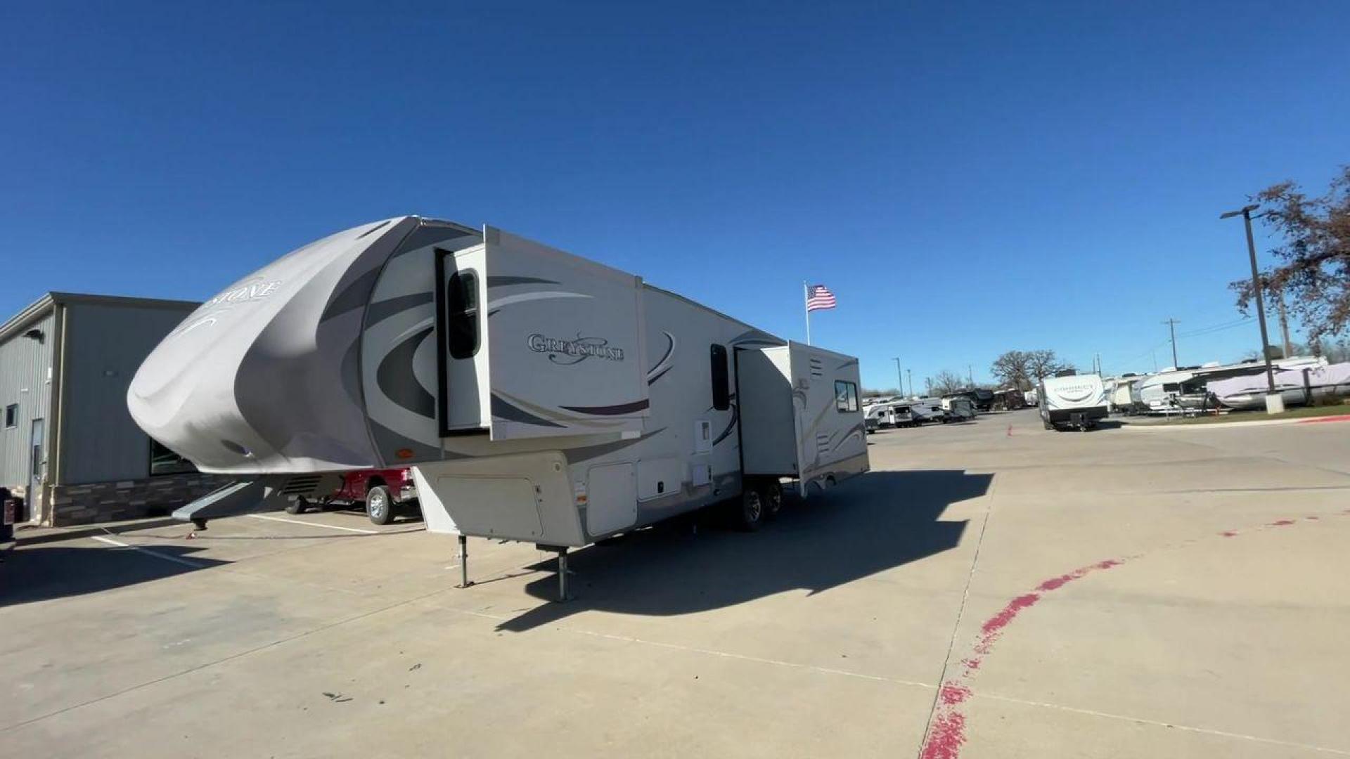 2011 WHITE HEARTLAND GREYSTONE 32RE (5SFSG3228BE) , Length: 34.83 ft. | Dry Weight: 10,421 lbs. | Gross Weight: 13,840 lbs. | Slides: 3 transmission, located at 4319 N Main St, Cleburne, TX, 76033, (817) 678-5133, 32.385960, -97.391212 - This 2011 Heartland Greystone 32RE is a dual-axle aluminum wheel setup measuring nearly 35 feet long. It has a dry weight of 10,421 lbs. and a GVWR of 13,840 lbs. It includes three power slides as well as one 16-foot power awning. This unit features a classic rear living and front bedroom floor plan - Photo#5