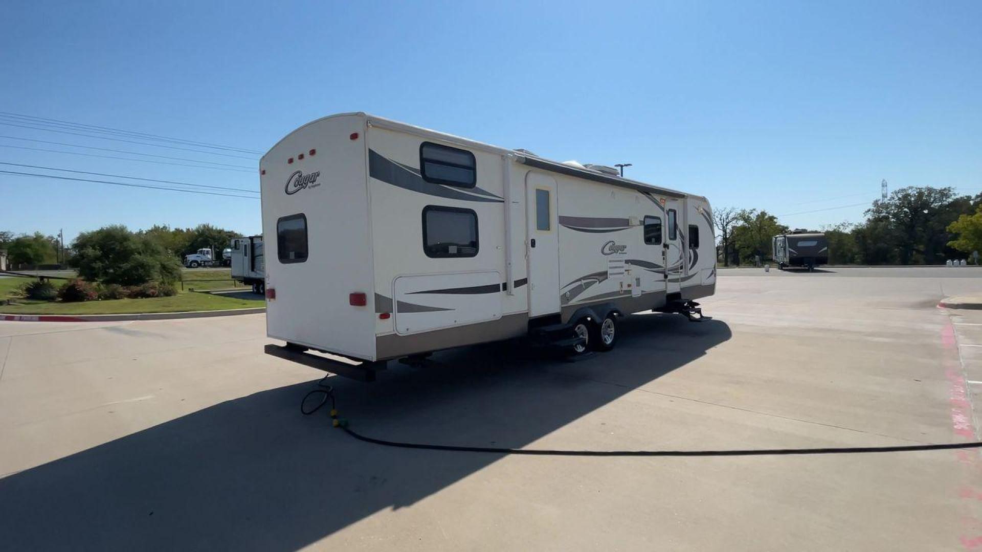 2011 KEYSTONE COUGAR 31SQB (4YDT31S20BV) , Length: 35.42 ft. | Dry Weight: 7,015 lbs. | Gross Weight: 9,000 lbs. | Slides: 2 transmission, located at 4319 N Main St, Cleburne, TX, 76033, (817) 678-5133, 32.385960, -97.391212 - Photo#1