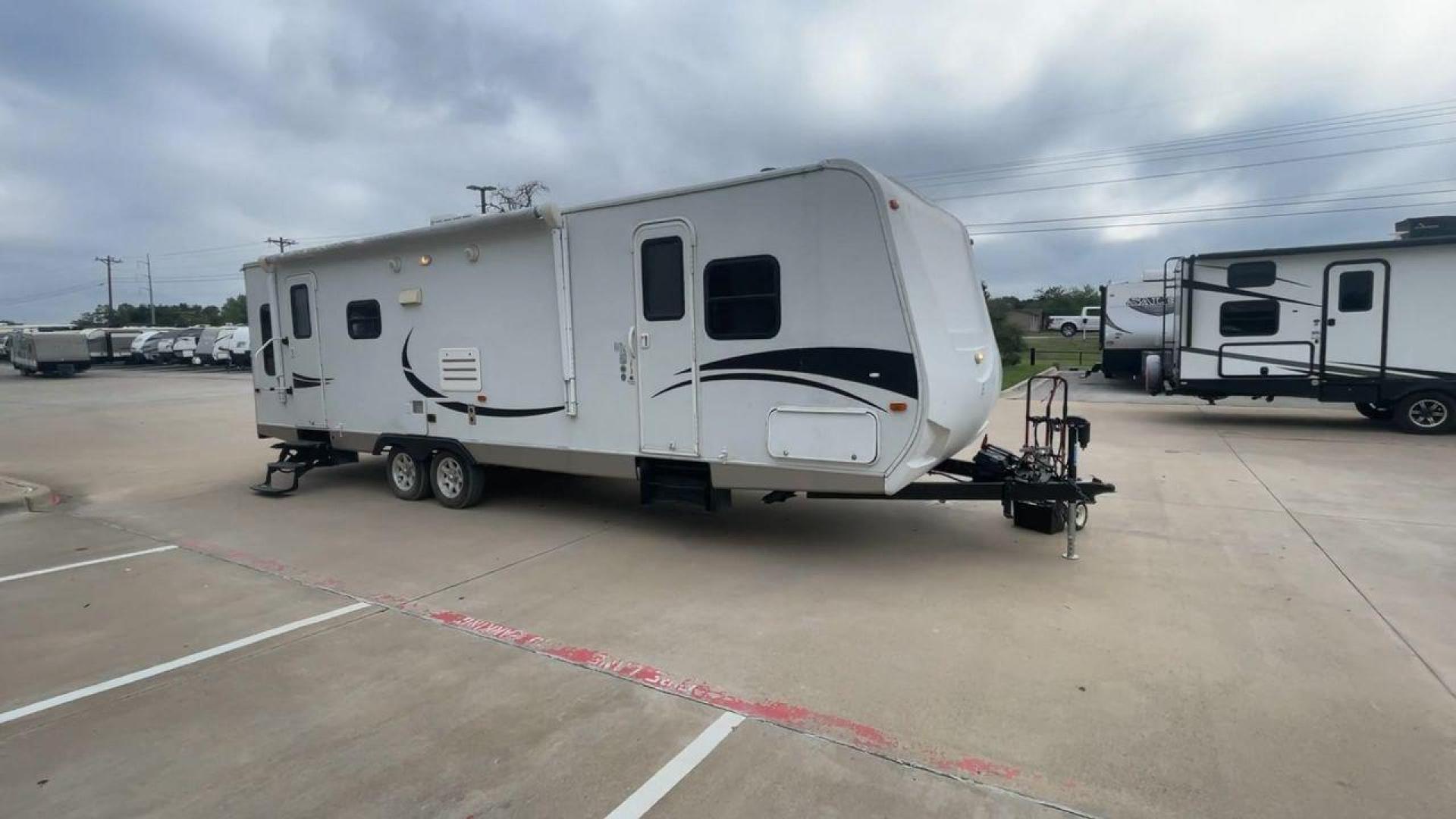 2011 KZ SPREE 323 RL (4EZTP3225B8) , located at 4319 N Main St, Cleburne, TX, 76033, (817) 678-5133, 32.385960, -97.391212 - The 2011 KZSP CT features a clean and functional exterior design with practicality at its core. The white exterior is complemented by simple black graphic accents that stretch along the sides, providing a subtle yet stylish contrast. At the rear, the trailer includes a window for added natural light - Photo#3