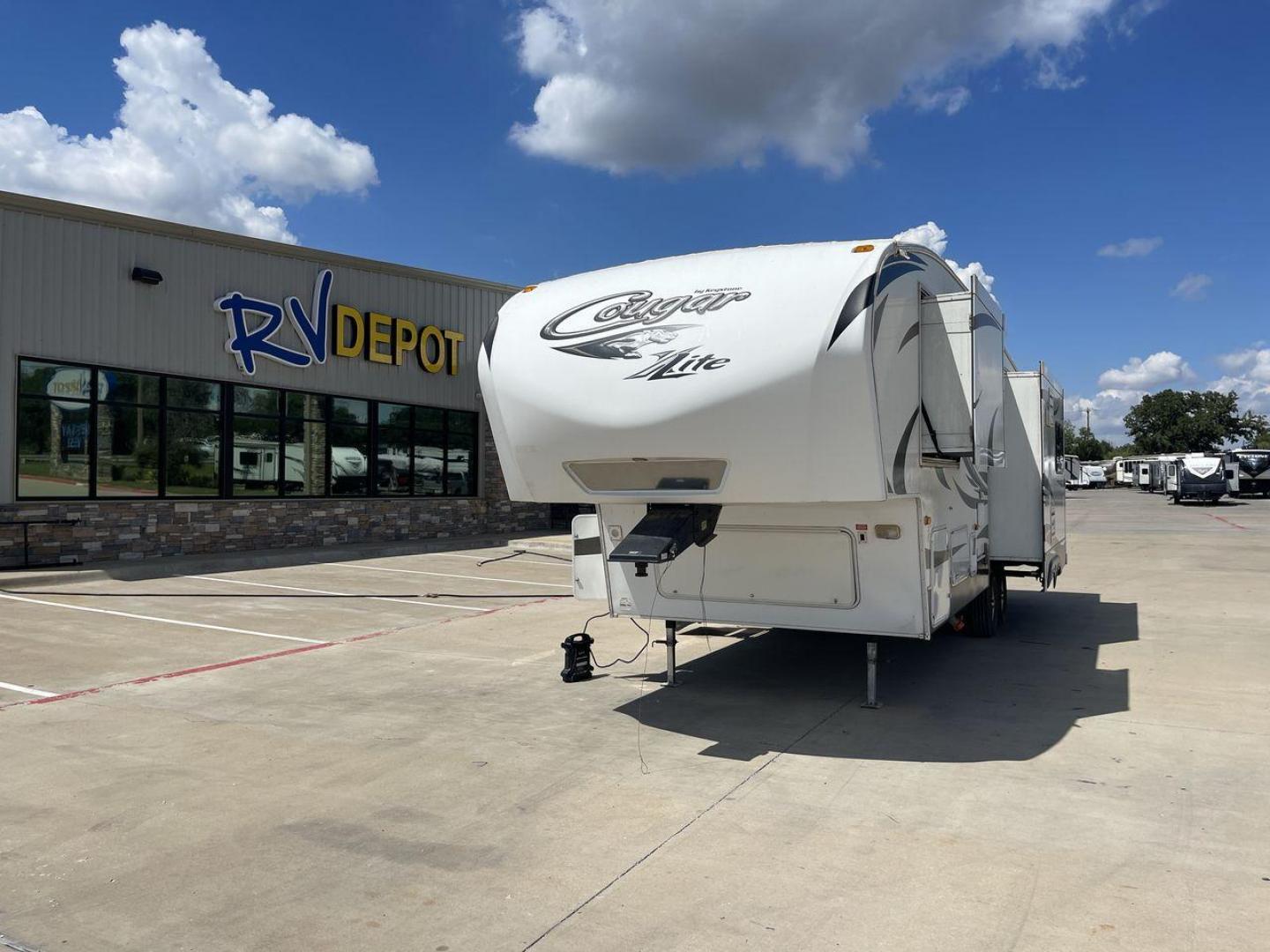 2012 BROWN KEYSTONE COUGAR 28SGS (4YDF28S25C2) , Length: 30.83 ft. | Dry Weight: 7,574 lbs. | Gross Weight: 10,000 lbs.| Slides: 3 transmission, located at 4319 N Main St, Cleburne, TX, 76033, (817) 678-5133, 32.385960, -97.391212 - The 2012 Cougar 28SGS is a spacious fifth wheel that offers both comfort and style for your travel adventures. At 30.83 feet in length, this trailer features a dry weight of 7,574 lbs. and a gross weight of 10,000 lbs., making it a versatile option for towing with various vehicles. The Cougar is equ - Photo#0