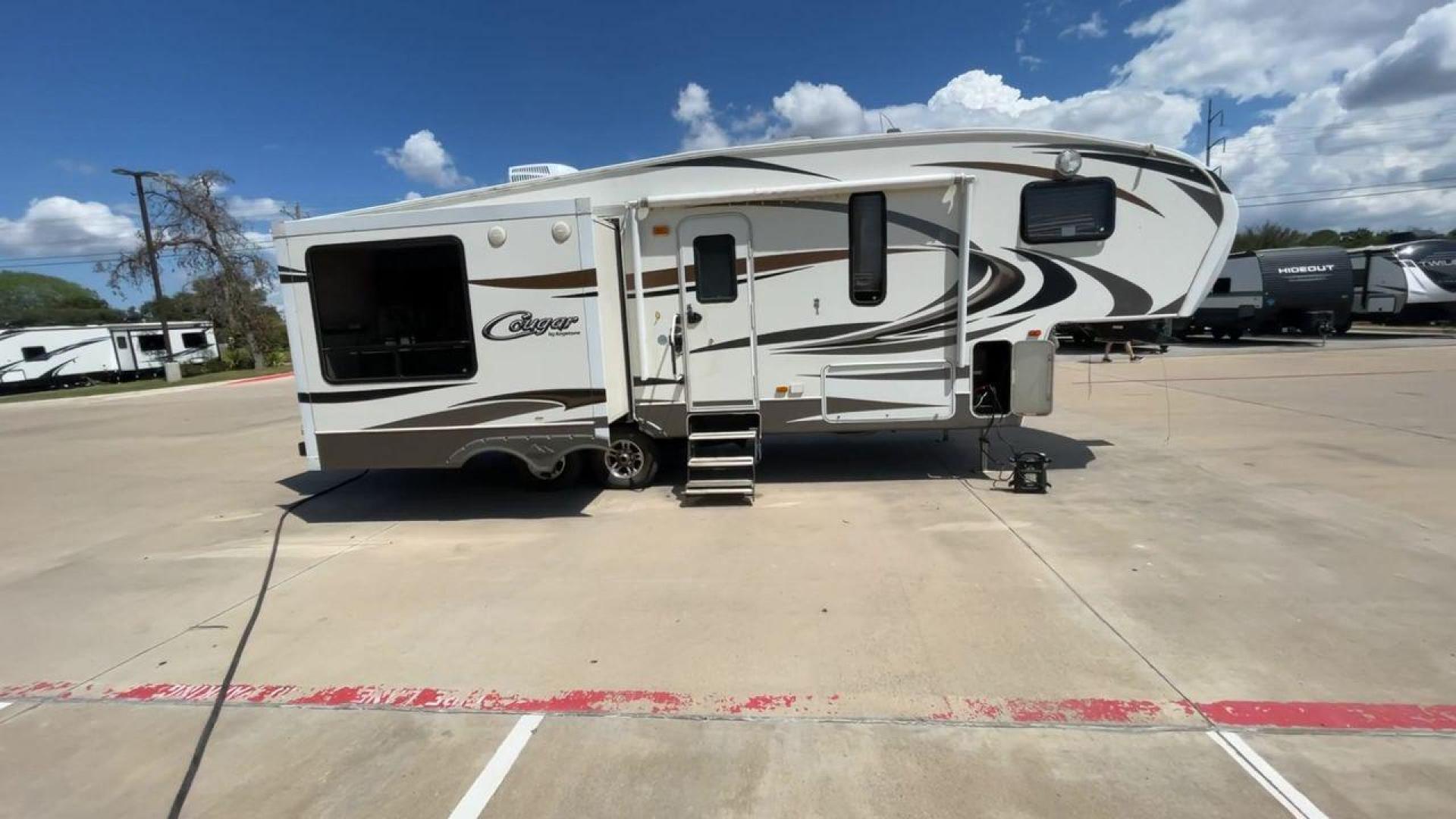 2012 BROWN KEYSTONE COUGAR 28SGS (4YDF28S25C2) , Length: 30.83 ft. | Dry Weight: 7,574 lbs. | Gross Weight: 10,000 lbs.| Slides: 3 transmission, located at 4319 N Main St, Cleburne, TX, 76033, (817) 678-5133, 32.385960, -97.391212 - The 2012 Cougar 28SGS is a spacious fifth wheel that offers both comfort and style for your travel adventures. At 30.83 feet in length, this trailer features a dry weight of 7,574 lbs. and a gross weight of 10,000 lbs., making it a versatile option for towing with various vehicles. The Cougar is equ - Photo#2