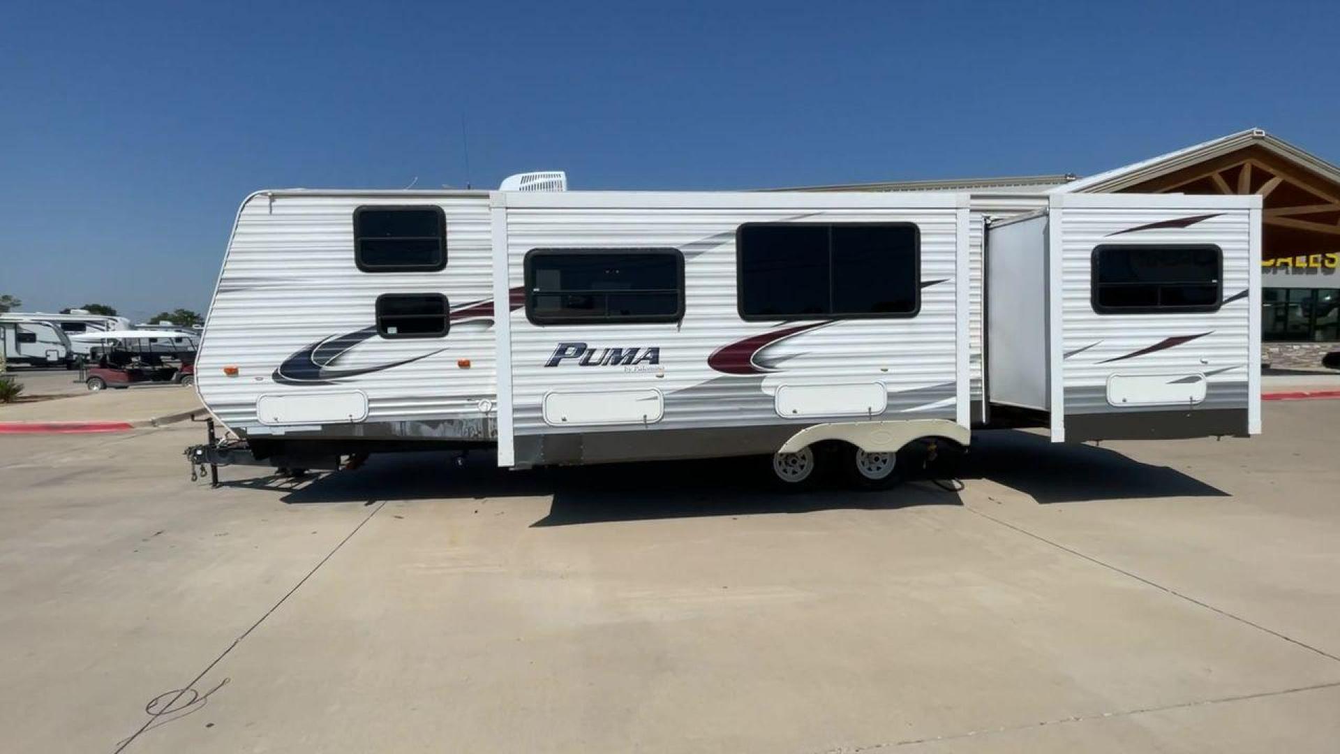 2012 WHITE PUMA 30KFB (4X4TPUF27CP) , Length: 34.75 ft. | Dry Weight: 8,130 lbs. | Gross Weight: 11,315 lbs. | Slides: 2 transmission, located at 4319 N Main St, Cleburne, TX, 76033, (817) 678-5133, 32.385960, -97.391212 - The 2012 Puma 30KFB travel trailer has 34.75 ft length, 8 ft width, 11.08 ft height, and 6.67 ft interior height. The dry weight of this unit is about 8,130 lbs, with a payload capacity of 3,125 lbs. It has a GVWR of 11,315 lbs and a hitch weight of 1,155 lbs. This unit highlights an outdoor fro - Photo#5