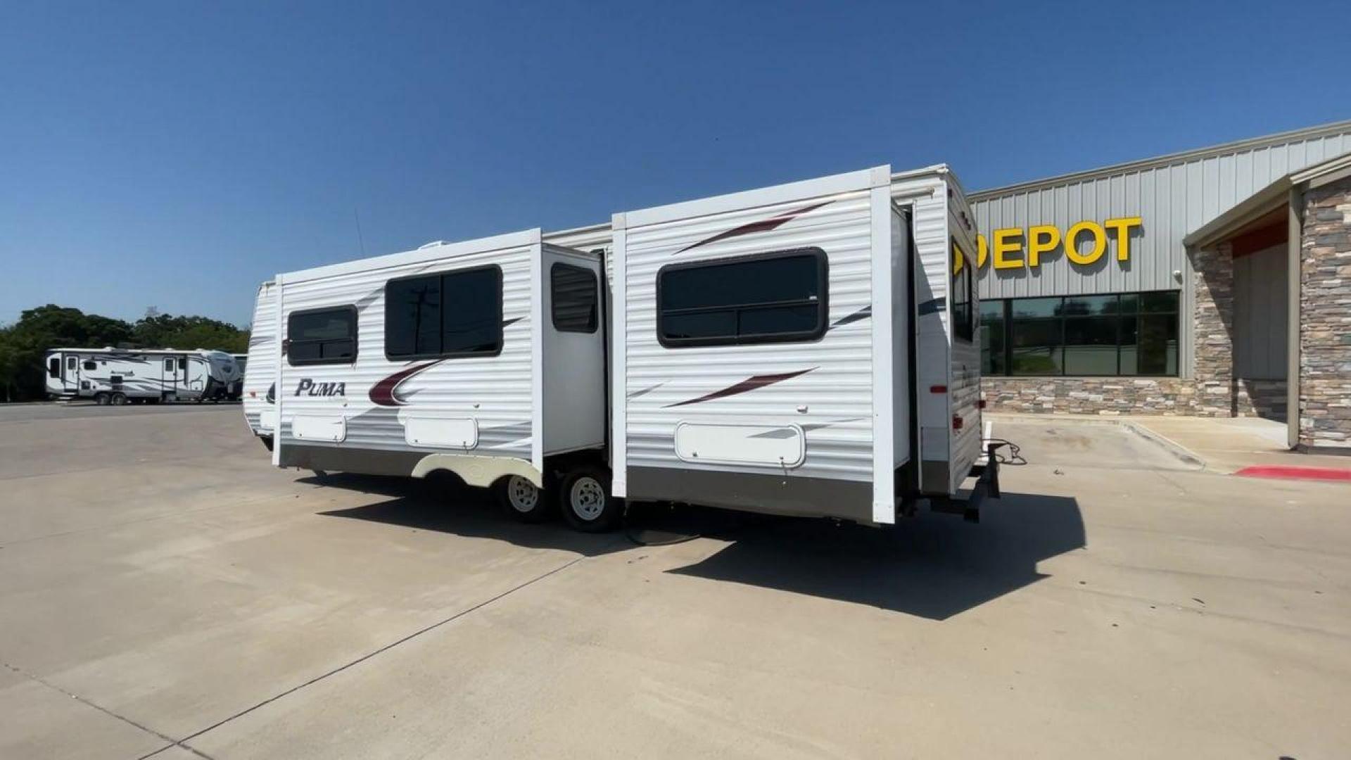 2012 WHITE PUMA 30KFB (4X4TPUF27CP) , Length: 34.75 ft. | Dry Weight: 8,130 lbs. | Gross Weight: 11,315 lbs. | Slides: 2 transmission, located at 4319 N Main St, Cleburne, TX, 76033, (817) 678-5133, 32.385960, -97.391212 - The 2012 Puma 30KFB travel trailer has 34.75 ft length, 8 ft width, 11.08 ft height, and 6.67 ft interior height. The dry weight of this unit is about 8,130 lbs, with a payload capacity of 3,125 lbs. It has a GVWR of 11,315 lbs and a hitch weight of 1,155 lbs. This unit highlights an outdoor fro - Photo#6