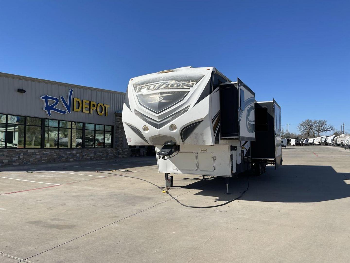 2013 WHITE KEYSTONE FUZION FZ399 - (4YDF39923DF) , Length: 41 ft. | Dry Weight: 13,880 lbs. | Gross Weight: 18,000 lbs. | Slides: 3 transmission, located at 4319 N Main St, Cleburne, TX, 76033, (817) 678-5133, 32.385960, -97.391212 - The 2013 Keystone Fuzion FZ399 toy hauler measures 41 ft in length, 8.5 ft in width, and 13.25 ft in height. It has a dry weight of 13,880 lbs with a payload capacity of 4,120 lbs. The GVWR is 18,000 lbs and has a hitch weight of 3,560 lbs. This has a triple axle and triple slide with one 20 ft powe - Photo#0