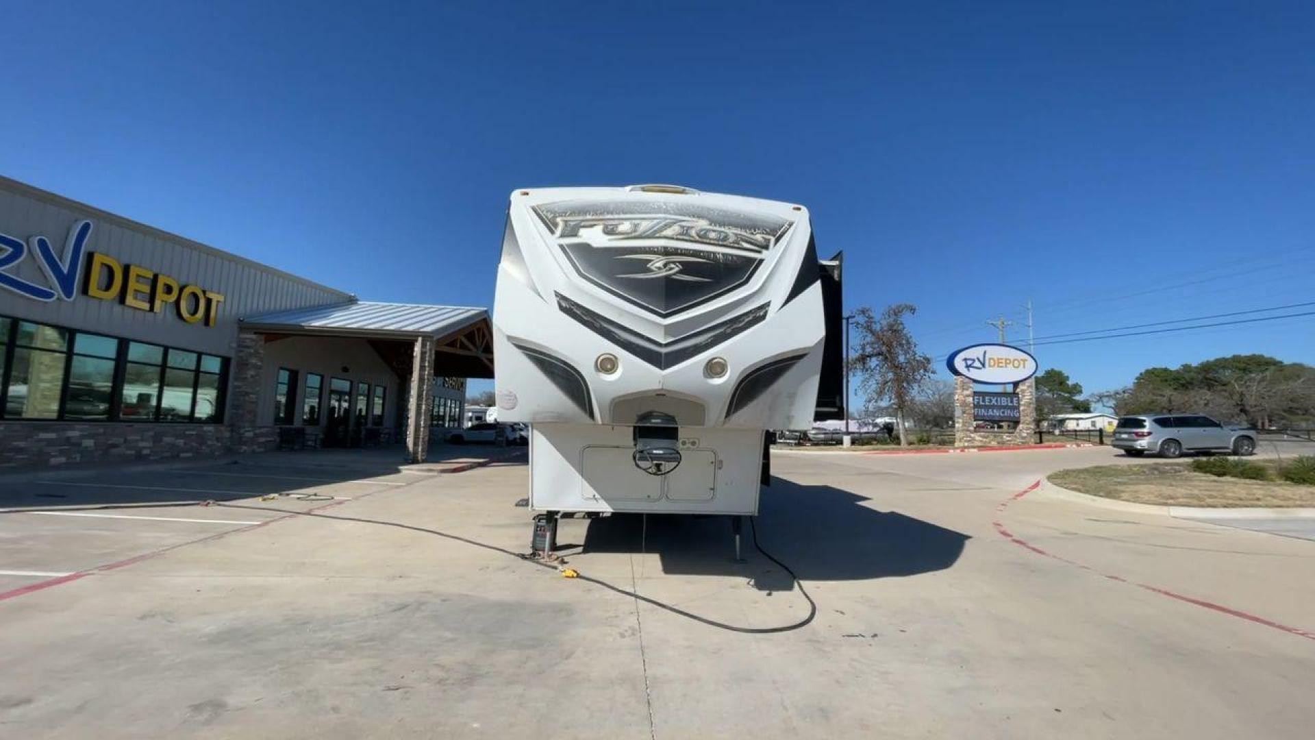 2013 WHITE KEYSTONE FUZION FZ399 - (4YDF39923DF) , Length: 41 ft. | Dry Weight: 13,880 lbs. | Gross Weight: 18,000 lbs. | Slides: 3 transmission, located at 4319 N Main St, Cleburne, TX, 76033, (817) 678-5133, 32.385960, -97.391212 - The 2013 Keystone Fuzion FZ399 toy hauler measures 41 ft in length, 8.5 ft in width, and 13.25 ft in height. It has a dry weight of 13,880 lbs with a payload capacity of 4,120 lbs. The GVWR is 18,000 lbs and has a hitch weight of 3,560 lbs. This has a triple axle and triple slide with one 20 ft powe - Photo#4