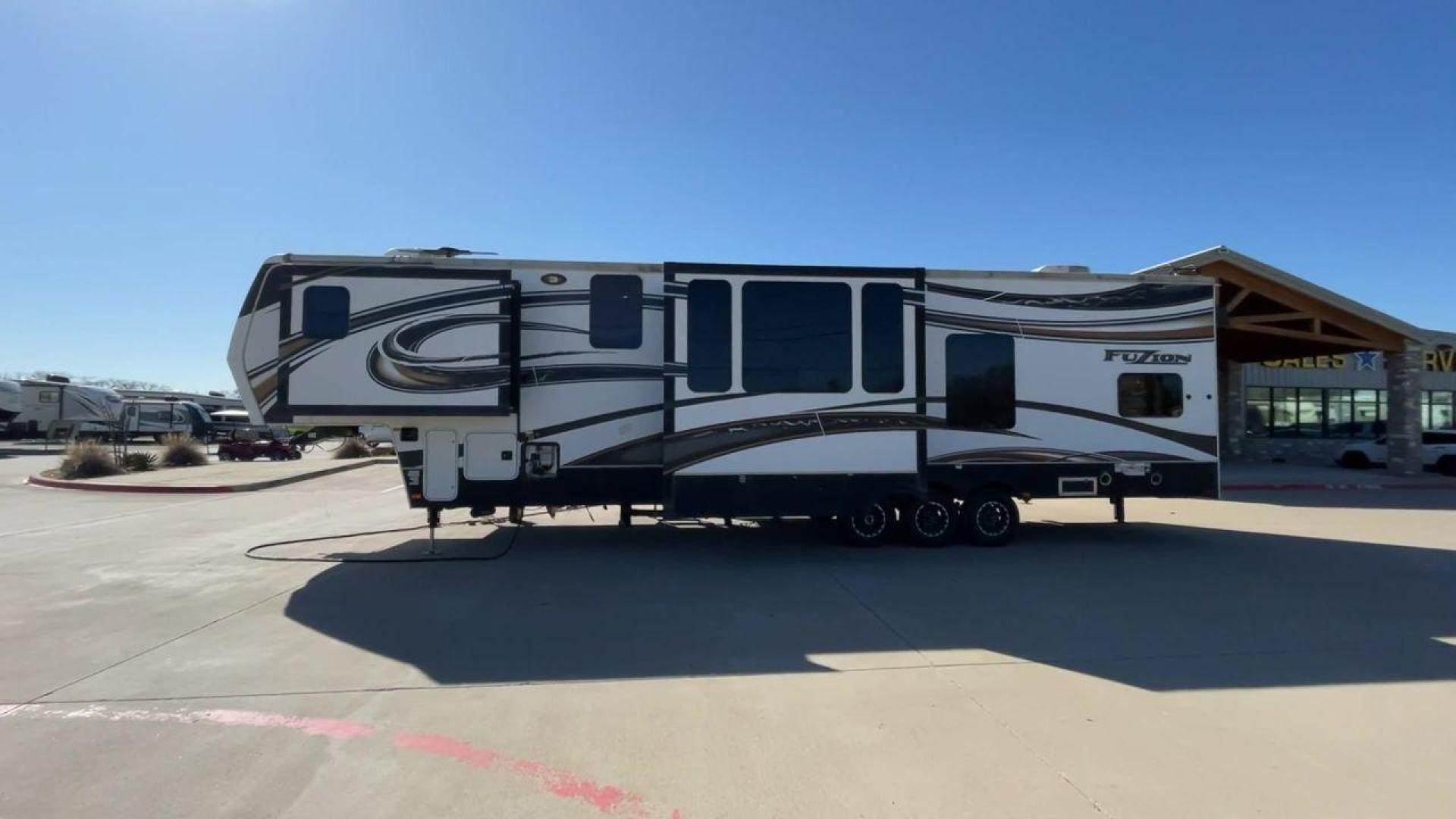 2013 WHITE KEYSTONE FUZION FZ399 - (4YDF39923DF) , Length: 41 ft. | Dry Weight: 13,880 lbs. | Gross Weight: 18,000 lbs. | Slides: 3 transmission, located at 4319 N Main St, Cleburne, TX, 76033, (817) 678-5133, 32.385960, -97.391212 - The 2013 Keystone Fuzion FZ399 toy hauler measures 41 ft in length, 8.5 ft in width, and 13.25 ft in height. It has a dry weight of 13,880 lbs with a payload capacity of 4,120 lbs. The GVWR is 18,000 lbs and has a hitch weight of 3,560 lbs. This has a triple axle and triple slide with one 20 ft powe - Photo#6