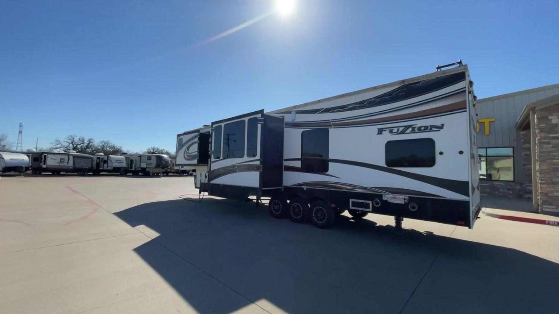 2013 WHITE KEYSTONE FUZION FZ399 - (4YDF39923DF) , Length: 41 ft. | Dry Weight: 13,880 lbs. | Gross Weight: 18,000 lbs. | Slides: 3 transmission, located at 4319 N Main St, Cleburne, TX, 76033, (817) 678-5133, 32.385960, -97.391212 - The 2013 Keystone Fuzion FZ399 toy hauler measures 41 ft in length, 8.5 ft in width, and 13.25 ft in height. It has a dry weight of 13,880 lbs with a payload capacity of 4,120 lbs. The GVWR is 18,000 lbs and has a hitch weight of 3,560 lbs. This has a triple axle and triple slide with one 20 ft powe - Photo#7