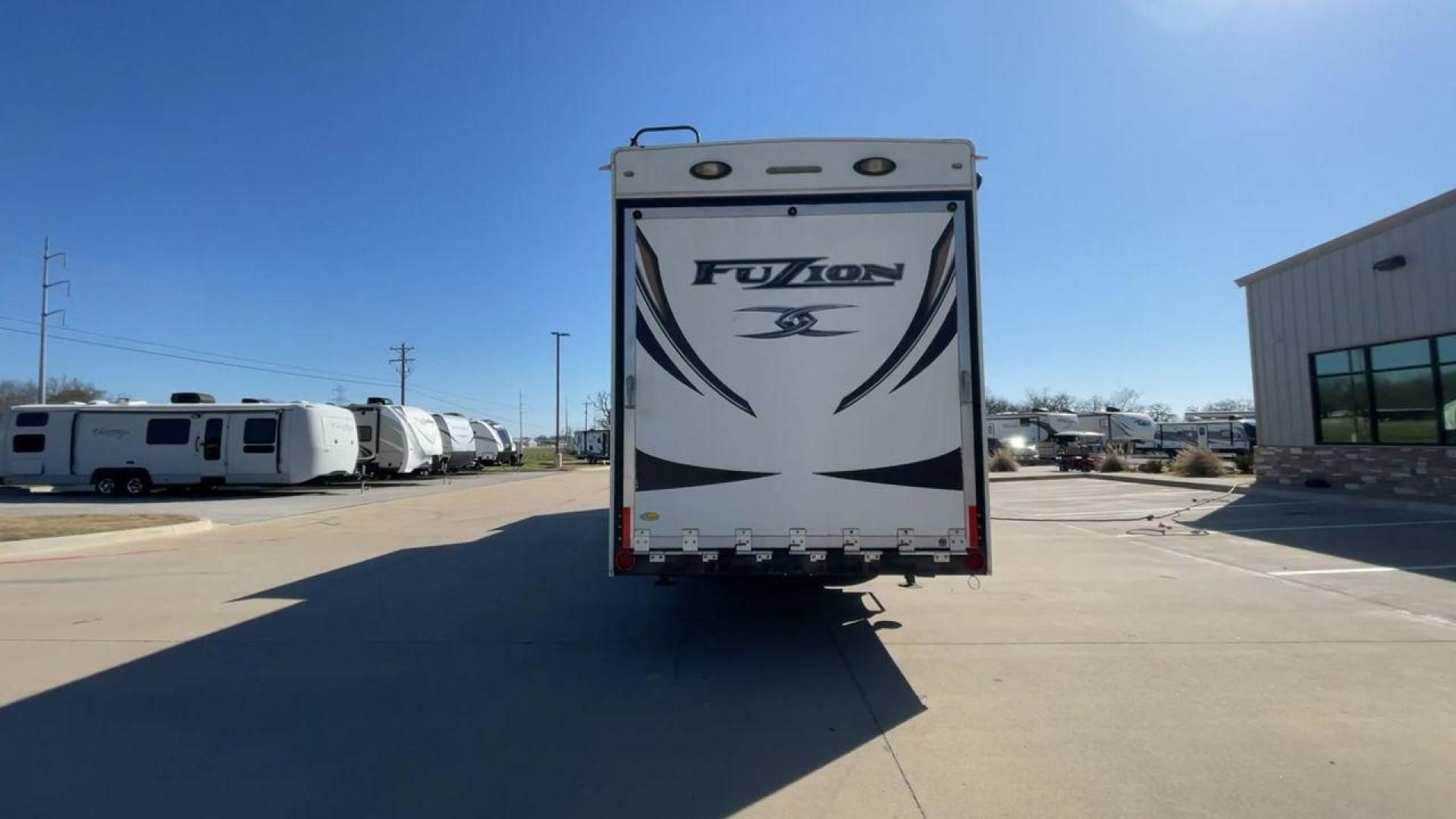 2013 WHITE KEYSTONE FUZION FZ399 - (4YDF39923DF) , Length: 41 ft. | Dry Weight: 13,880 lbs. | Gross Weight: 18,000 lbs. | Slides: 3 transmission, located at 4319 N Main St, Cleburne, TX, 76033, (817) 678-5133, 32.385960, -97.391212 - The 2013 Keystone Fuzion FZ399 toy hauler measures 41 ft in length, 8.5 ft in width, and 13.25 ft in height. It has a dry weight of 13,880 lbs with a payload capacity of 4,120 lbs. The GVWR is 18,000 lbs and has a hitch weight of 3,560 lbs. This has a triple axle and triple slide with one 20 ft powe - Photo#8