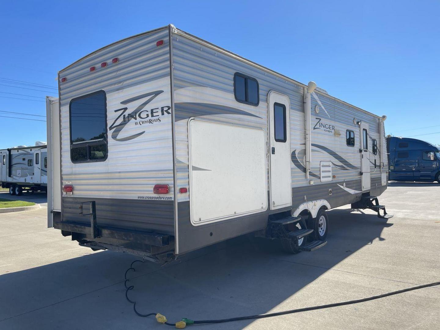 2013 WHITE ZINGER 31SB (4V0TC3129DJ) , Length: 35.5 ft. | Dry Weight: 7,875 lbs. | Gross Weight: 9,671 lbs. | Slides: 2 transmission, located at 4319 N Main St, Cleburne, TX, 76033, (817) 678-5133, 32.385960, -97.391212 - This 2013 Zinger 31SB is a dual-axle steel wheel setup measuring 35.5 ft. long and 11.42 ft. tall. It has a dry weight of 7,875 lbs. and a GVWR of 9,671 lbs. It is designed with two doors, two slides, and one awning. The interior features two bedrooms, a bathroom, a kitchen, and a living area. The f - Photo#24