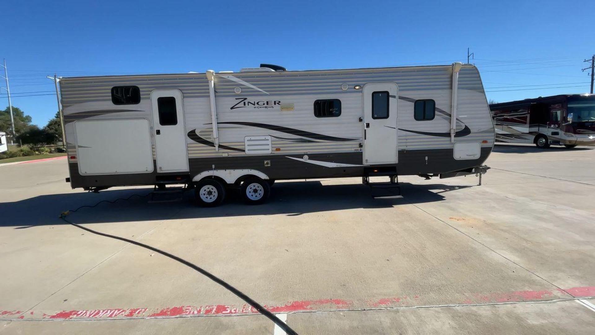 2013 WHITE ZINGER 31SB (4V0TC3129DJ) , Length: 35.5 ft. | Dry Weight: 7,875 lbs. | Gross Weight: 9,671 lbs. | Slides: 2 transmission, located at 4319 N Main St, Cleburne, TX, 76033, (817) 678-5133, 32.385960, -97.391212 - This 2013 Zinger 31SB is a dual-axle steel wheel setup measuring 35.5 ft. long and 11.42 ft. tall. It has a dry weight of 7,875 lbs. and a GVWR of 9,671 lbs. It is designed with two doors, two slides, and one awning. The interior features two bedrooms, a bathroom, a kitchen, and a living area. The f - Photo#2