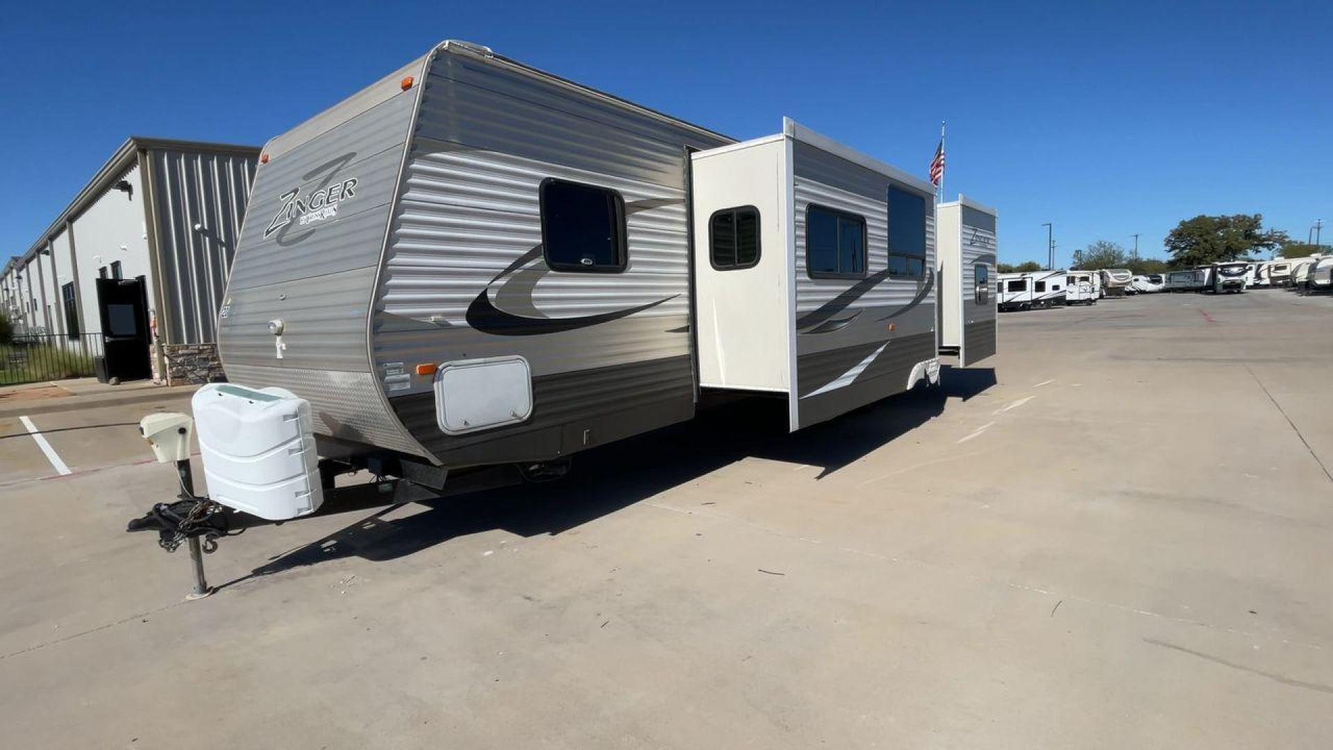 2013 WHITE ZINGER 31SB (4V0TC3129DJ) , Length: 35.5 ft. | Dry Weight: 7,875 lbs. | Gross Weight: 9,671 lbs. | Slides: 2 transmission, located at 4319 N Main St, Cleburne, TX, 76033, (817) 678-5133, 32.385960, -97.391212 - This 2013 Zinger 31SB is a dual-axle steel wheel setup measuring 35.5 ft. long and 11.42 ft. tall. It has a dry weight of 7,875 lbs. and a GVWR of 9,671 lbs. It is designed with two doors, two slides, and one awning. The interior features two bedrooms, a bathroom, a kitchen, and a living area. The f - Photo#5