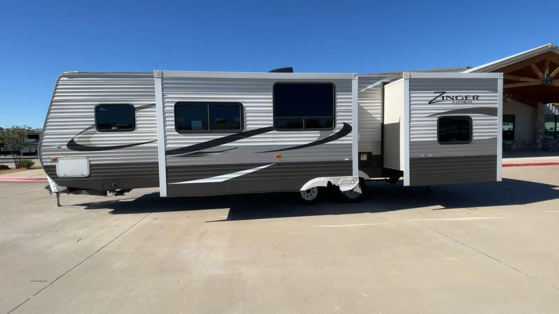 2013 WHITE ZINGER 31SB (4V0TC3129DJ) , Length: 35.5 ft. | Dry Weight: 7,875 lbs. | Gross Weight: 9,671 lbs. | Slides: 2 transmission, located at 4319 N Main St, Cleburne, TX, 76033, (817) 678-5133, 32.385960, -97.391212 - This 2013 Zinger 31SB is a dual-axle steel wheel setup measuring 35.5 ft. long and 11.42 ft. tall. It has a dry weight of 7,875 lbs. and a GVWR of 9,671 lbs. It is designed with two doors, two slides, and one awning. The interior features two bedrooms, a bathroom, a kitchen, and a living area. The f - Photo#6