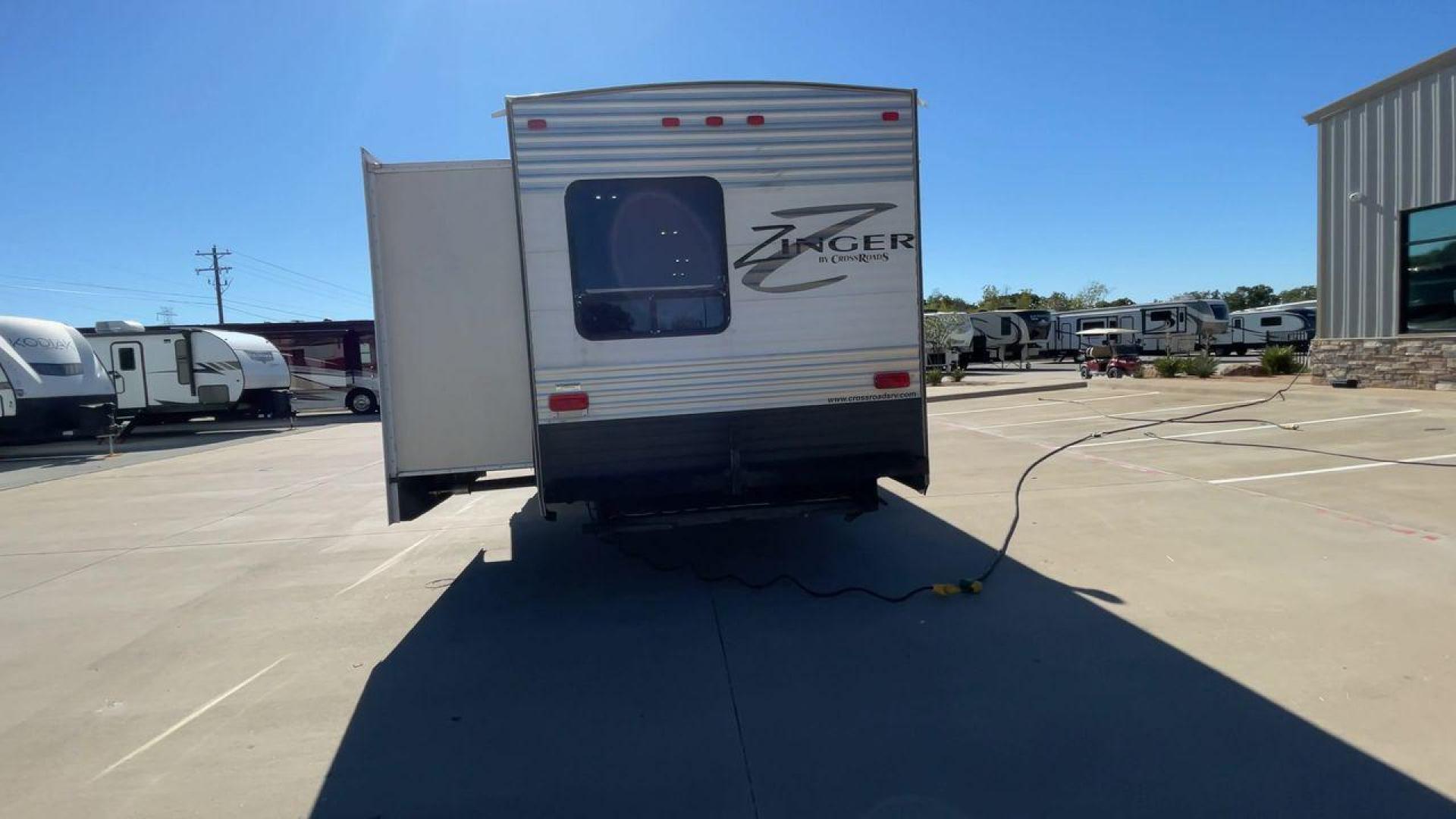 2013 WHITE ZINGER 31SB (4V0TC3129DJ) , Length: 35.5 ft. | Dry Weight: 7,875 lbs. | Gross Weight: 9,671 lbs. | Slides: 2 transmission, located at 4319 N Main St, Cleburne, TX, 76033, (817) 678-5133, 32.385960, -97.391212 - This 2013 Zinger 31SB is a dual-axle steel wheel setup measuring 35.5 ft. long and 11.42 ft. tall. It has a dry weight of 7,875 lbs. and a GVWR of 9,671 lbs. It is designed with two doors, two slides, and one awning. The interior features two bedrooms, a bathroom, a kitchen, and a living area. The f - Photo#8