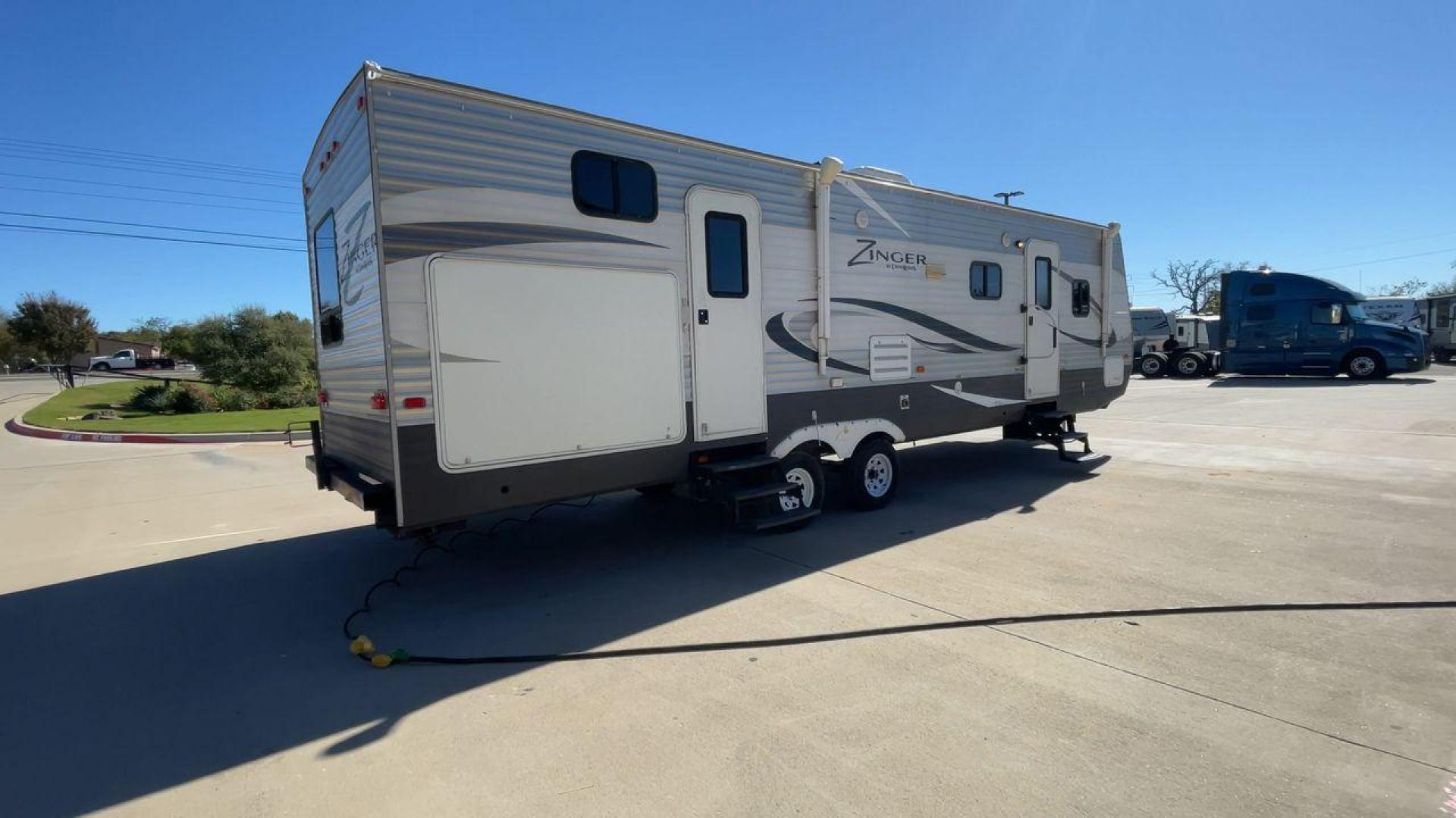 2013 WHITE ZINGER 31SB (4V0TC3129DJ) , Length: 35.5 ft. | Dry Weight: 7,875 lbs. | Gross Weight: 9,671 lbs. | Slides: 2 transmission, located at 4319 N Main St, Cleburne, TX, 76033, (817) 678-5133, 32.385960, -97.391212 - This 2013 Zinger 31SB is a dual-axle steel wheel setup measuring 35.5 ft. long and 11.42 ft. tall. It has a dry weight of 7,875 lbs. and a GVWR of 9,671 lbs. It is designed with two doors, two slides, and one awning. The interior features two bedrooms, a bathroom, a kitchen, and a living area. The f - Photo#1