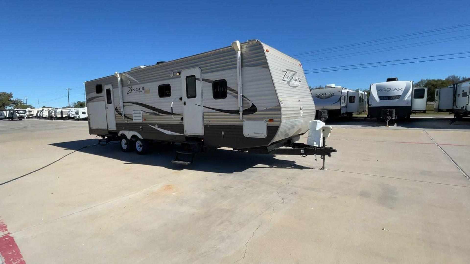 2013 WHITE ZINGER 31SB (4V0TC3129DJ) , Length: 35.5 ft. | Dry Weight: 7,875 lbs. | Gross Weight: 9,671 lbs. | Slides: 2 transmission, located at 4319 N Main St, Cleburne, TX, 76033, (817) 678-5133, 32.385960, -97.391212 - This 2013 Zinger 31SB is a dual-axle steel wheel setup measuring 35.5 ft. long and 11.42 ft. tall. It has a dry weight of 7,875 lbs. and a GVWR of 9,671 lbs. It is designed with two doors, two slides, and one awning. The interior features two bedrooms, a bathroom, a kitchen, and a living area. The f - Photo#3