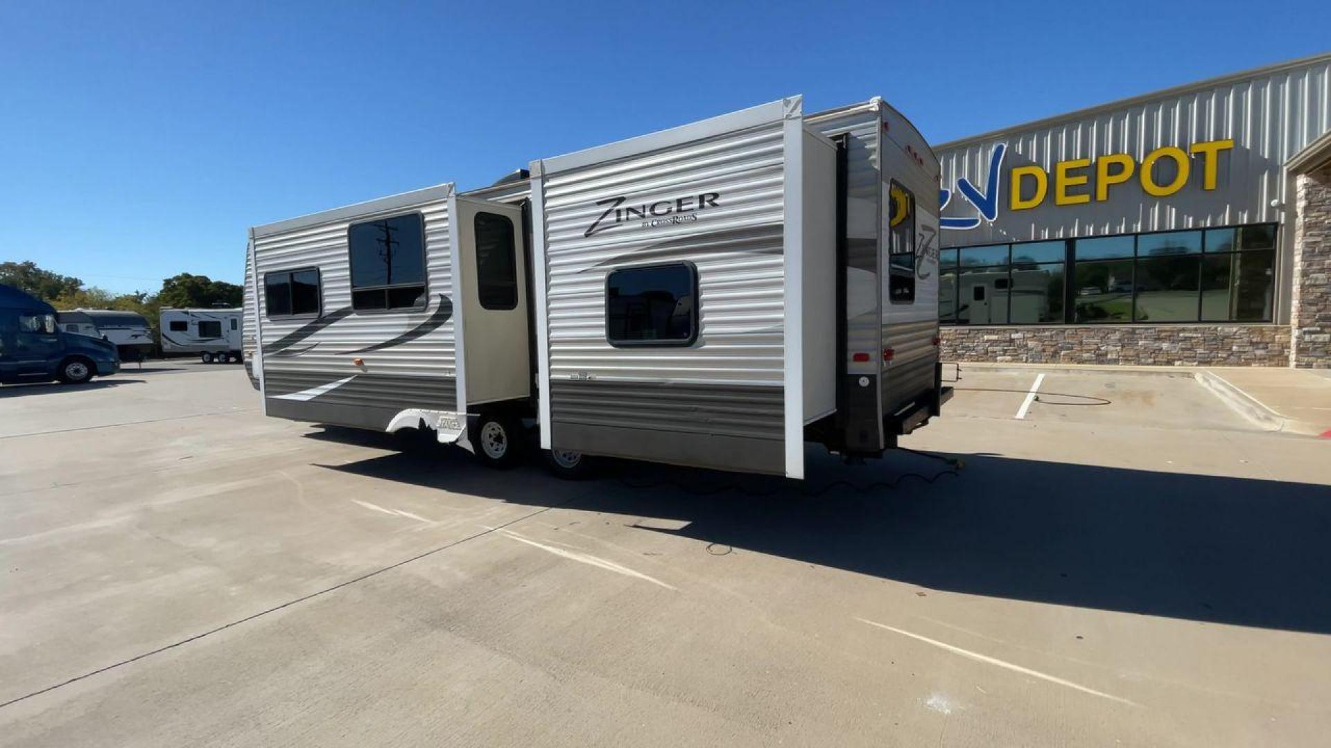 2013 WHITE ZINGER 31SB (4V0TC3129DJ) , Length: 35.5 ft. | Dry Weight: 7,875 lbs. | Gross Weight: 9,671 lbs. | Slides: 2 transmission, located at 4319 N Main St, Cleburne, TX, 76033, (817) 678-5133, 32.385960, -97.391212 - This 2013 Zinger 31SB is a dual-axle steel wheel setup measuring 35.5 ft. long and 11.42 ft. tall. It has a dry weight of 7,875 lbs. and a GVWR of 9,671 lbs. It is designed with two doors, two slides, and one awning. The interior features two bedrooms, a bathroom, a kitchen, and a living area. The f - Photo#7