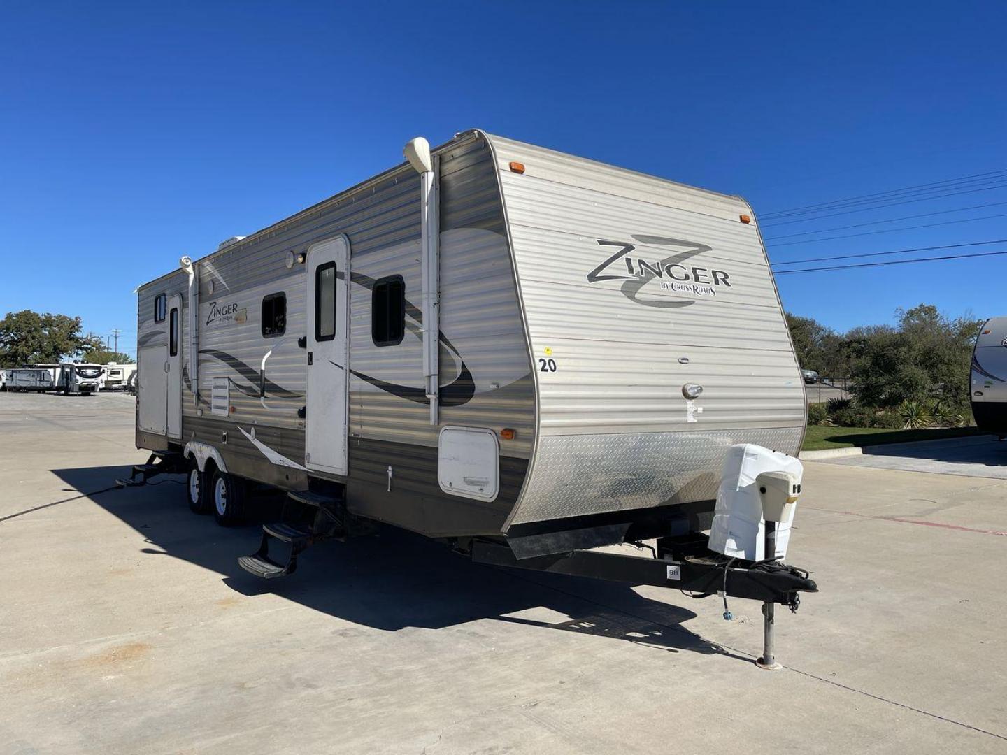 2013 WHITE ZINGER 31SB (4V0TC3129DJ) , Length: 35.5 ft. | Dry Weight: 7,875 lbs. | Gross Weight: 9,671 lbs. | Slides: 2 transmission, located at 4319 N Main St, Cleburne, TX, 76033, (817) 678-5133, 32.385960, -97.391212 - This 2013 Zinger 31SB is a dual-axle steel wheel setup measuring 35.5 ft. long and 11.42 ft. tall. It has a dry weight of 7,875 lbs. and a GVWR of 9,671 lbs. It is designed with two doors, two slides, and one awning. The interior features two bedrooms, a bathroom, a kitchen, and a living area. The f - Photo#23