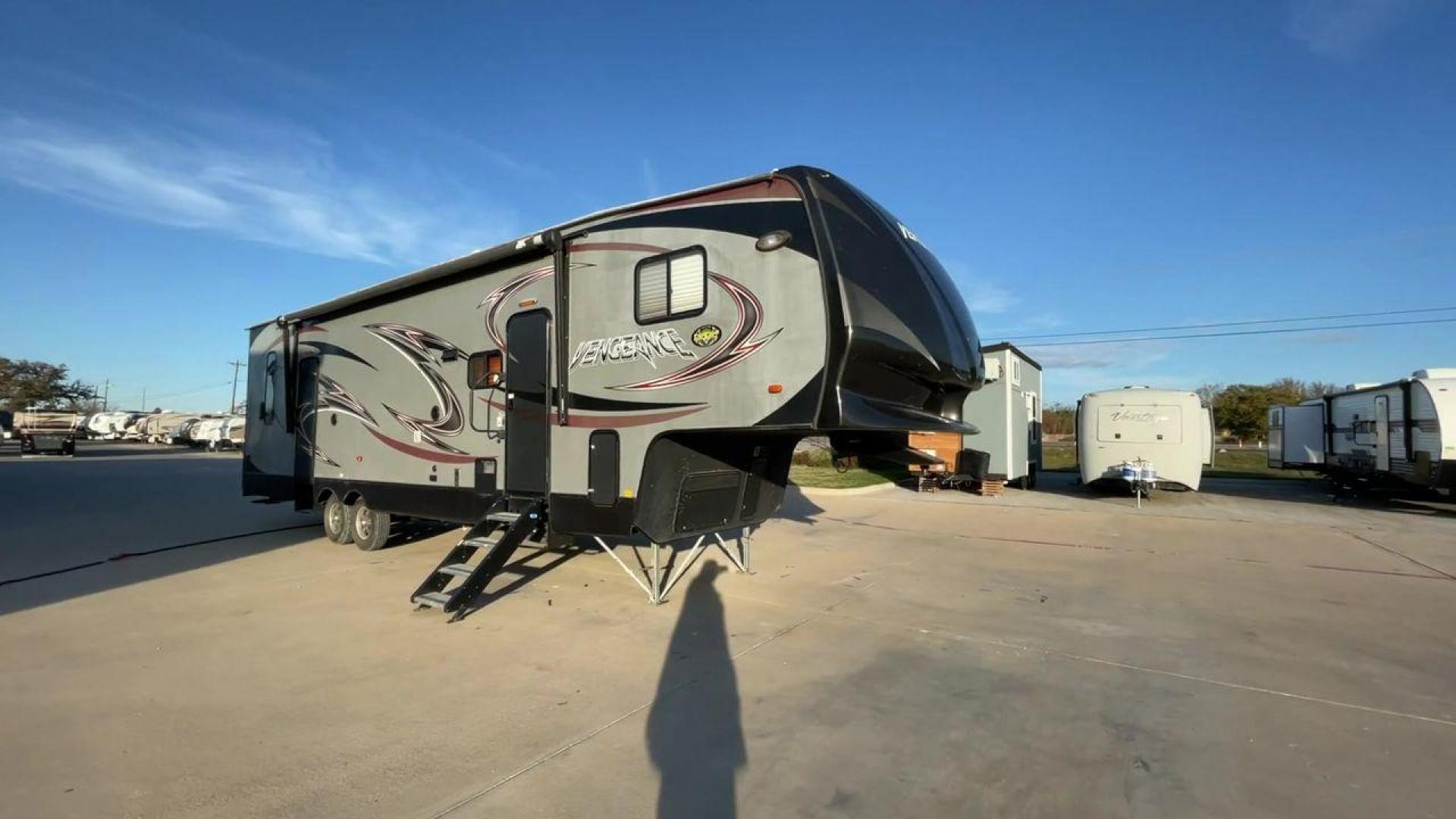 2014 WHITE FOREST RIVER VENGEANCE 312A (4X4FVGG22EY) , Length: 37.92 ft. | Dry Weight: 10,068 lbs. | Gross Weight: 14,508 lbs. | Slides: 1 transmission, located at 4319 N Main St, Cleburne, TX, 76033, (817) 678-5133, 32.385960, -97.391212 - This 2014 Vengeance Toy Hauler has a dry weight of 10,068 lbs and a GVWR of 14,508 lbs with a hitch weight of 2,508 lbs. This unit also has automatic heating and cooling for optimal temperature control. The exterior of this toy hauler is a simple cream base with black and red accents. This model als - Photo#3