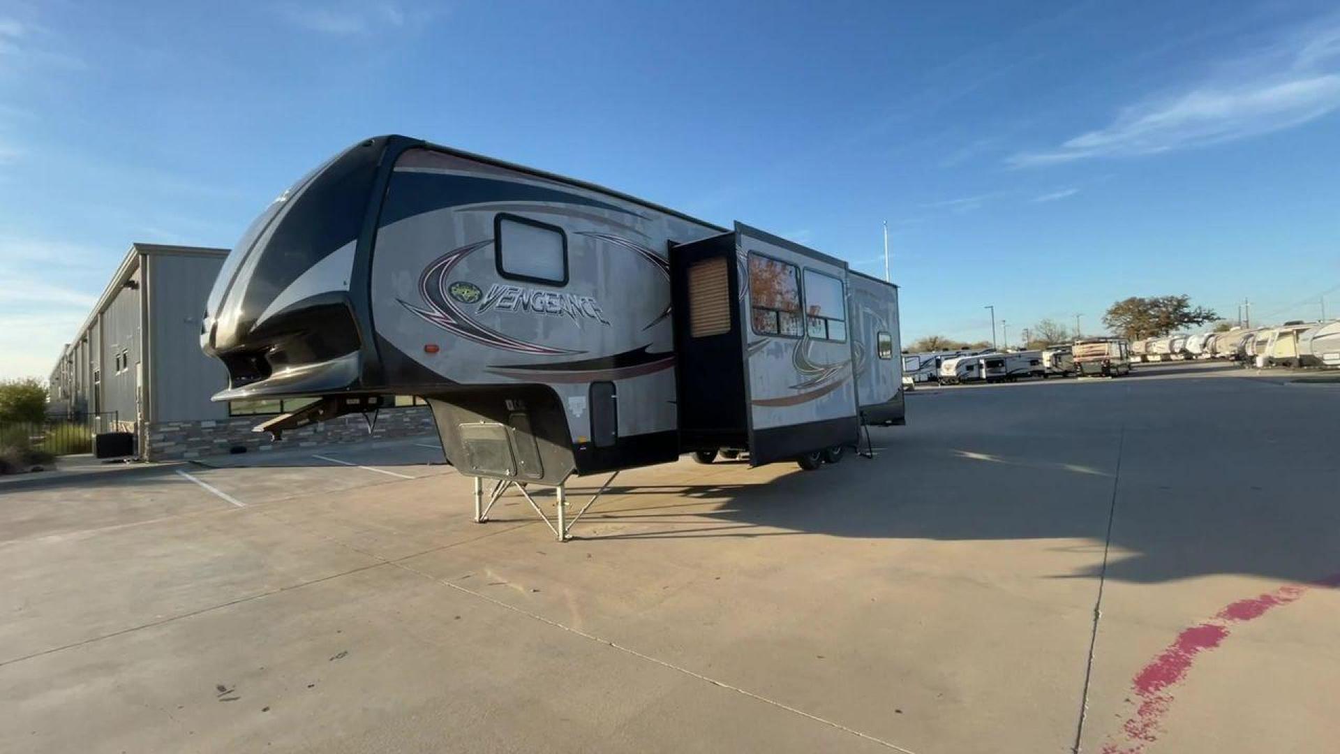 2014 WHITE FOREST RIVER VENGEANCE 312A (4X4FVGG22EY) , Length: 37.92 ft. | Dry Weight: 10,068 lbs. | Gross Weight: 14,508 lbs. | Slides: 1 transmission, located at 4319 N Main St, Cleburne, TX, 76033, (817) 678-5133, 32.385960, -97.391212 - This 2014 Vengeance Toy Hauler has a dry weight of 10,068 lbs and a GVWR of 14,508 lbs with a hitch weight of 2,508 lbs. This unit also has automatic heating and cooling for optimal temperature control. The exterior of this toy hauler is a simple cream base with black and red accents. This model als - Photo#5