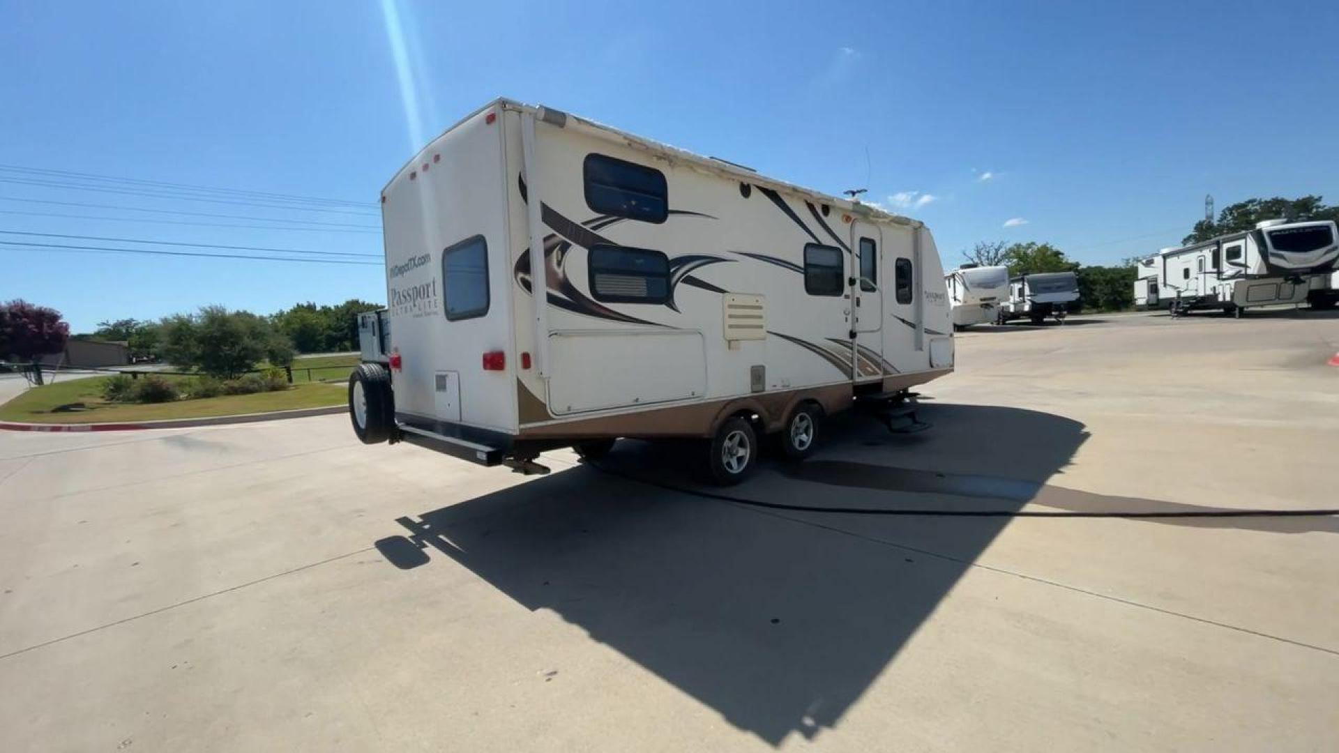 2014 WHITE KEYSTONE PASSPORT 2400BH (4YDT24029ET) , Length: 27.83 ft. | Dry Weight: 4,730 lbs. | Gross Weight: 6,800 lbs. | Slides: 1 transmission, located at 4319 N Main St, Cleburne, TX, 76033, (817) 678-5133, 32.385960, -97.391212 - The 2014 Keystone Passport 2400BH is a dual-axle steel wheel set-up that measures 27.83 ft. in length. It has a dry weight of 4,730 lbs. and a GVWR of 6,800 lbs. It also has a payload capacity of 2,070 lbs. and a hitch weight of 515 lbs. Its exterior is a base color of white with black and brown acc - Photo#1