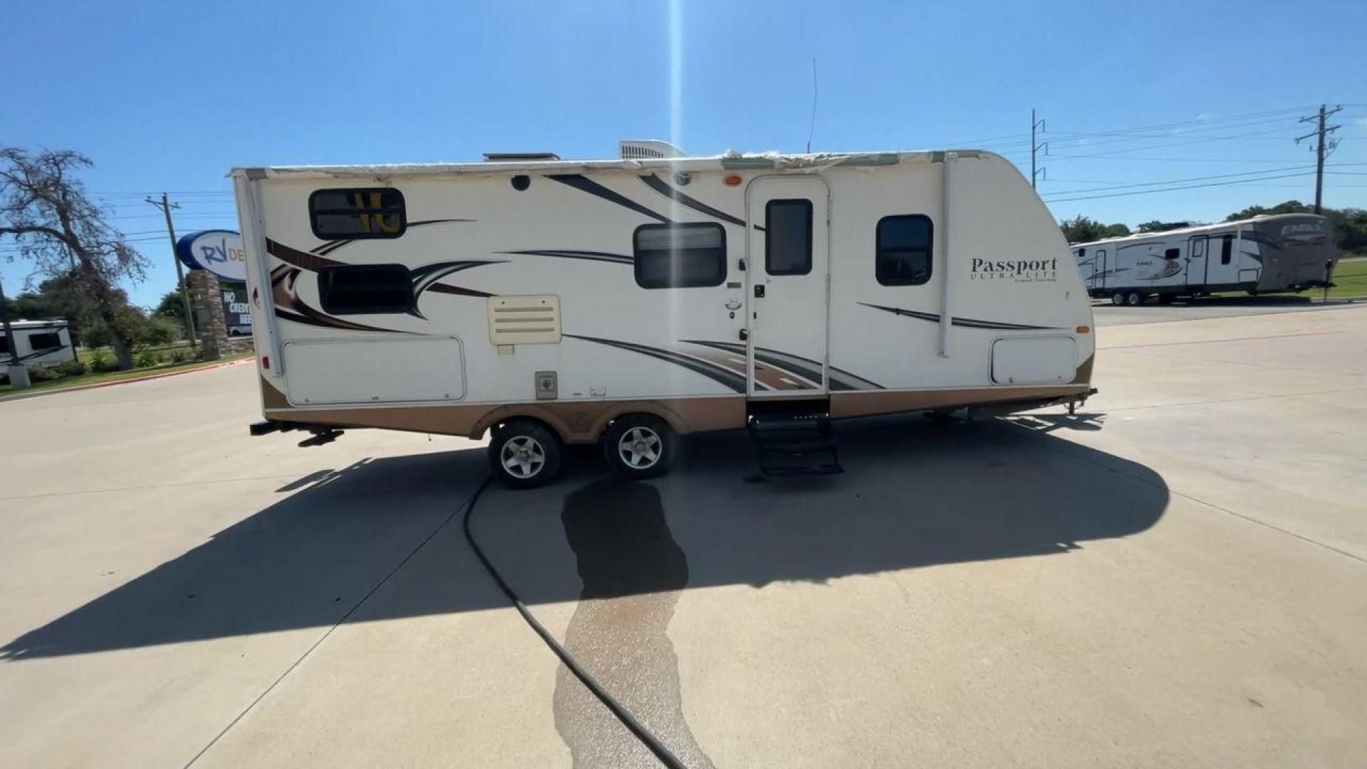 2014 WHITE KEYSTONE PASSPORT 2400BH (4YDT24029ET) , Length: 27.83 ft. | Dry Weight: 4,730 lbs. | Gross Weight: 6,800 lbs. | Slides: 1 transmission, located at 4319 N Main St, Cleburne, TX, 76033, (817) 678-5133, 32.385960, -97.391212 - The 2014 Keystone Passport 2400BH is a dual-axle steel wheel set-up that measures 27.83 ft. in length. It has a dry weight of 4,730 lbs. and a GVWR of 6,800 lbs. It also has a payload capacity of 2,070 lbs. and a hitch weight of 515 lbs. Its exterior is a base color of white with black and brown acc - Photo#2