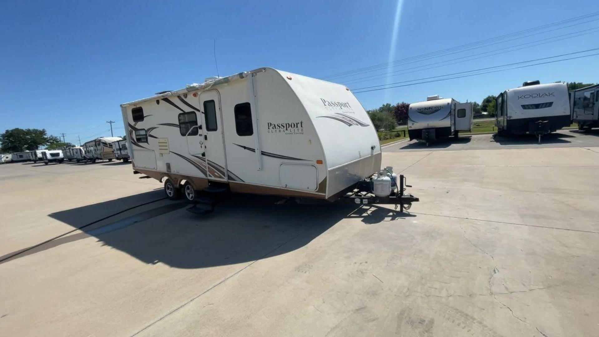 2014 WHITE KEYSTONE PASSPORT 2400BH (4YDT24029ET) , Length: 27.83 ft. | Dry Weight: 4,730 lbs. | Gross Weight: 6,800 lbs. | Slides: 1 transmission, located at 4319 N Main St, Cleburne, TX, 76033, (817) 678-5133, 32.385960, -97.391212 - The 2014 Keystone Passport 2400BH is a dual-axle steel wheel set-up that measures 27.83 ft. in length. It has a dry weight of 4,730 lbs. and a GVWR of 6,800 lbs. It also has a payload capacity of 2,070 lbs. and a hitch weight of 515 lbs. Its exterior is a base color of white with black and brown acc - Photo#3