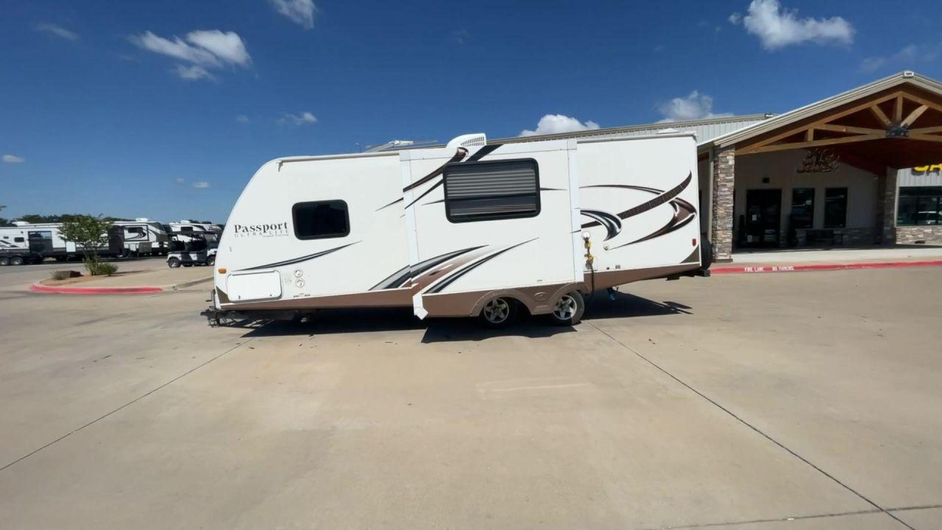 2014 WHITE KEYSTONE PASSPORT 2400BH (4YDT24029ET) , Length: 27.83 ft. | Dry Weight: 4,730 lbs. | Gross Weight: 6,800 lbs. | Slides: 1 transmission, located at 4319 N Main St, Cleburne, TX, 76033, (817) 678-5133, 32.385960, -97.391212 - The 2014 Keystone Passport 2400BH is a dual-axle steel wheel set-up that measures 27.83 ft. in length. It has a dry weight of 4,730 lbs. and a GVWR of 6,800 lbs. It also has a payload capacity of 2,070 lbs. and a hitch weight of 515 lbs. Its exterior is a base color of white with black and brown acc - Photo#6