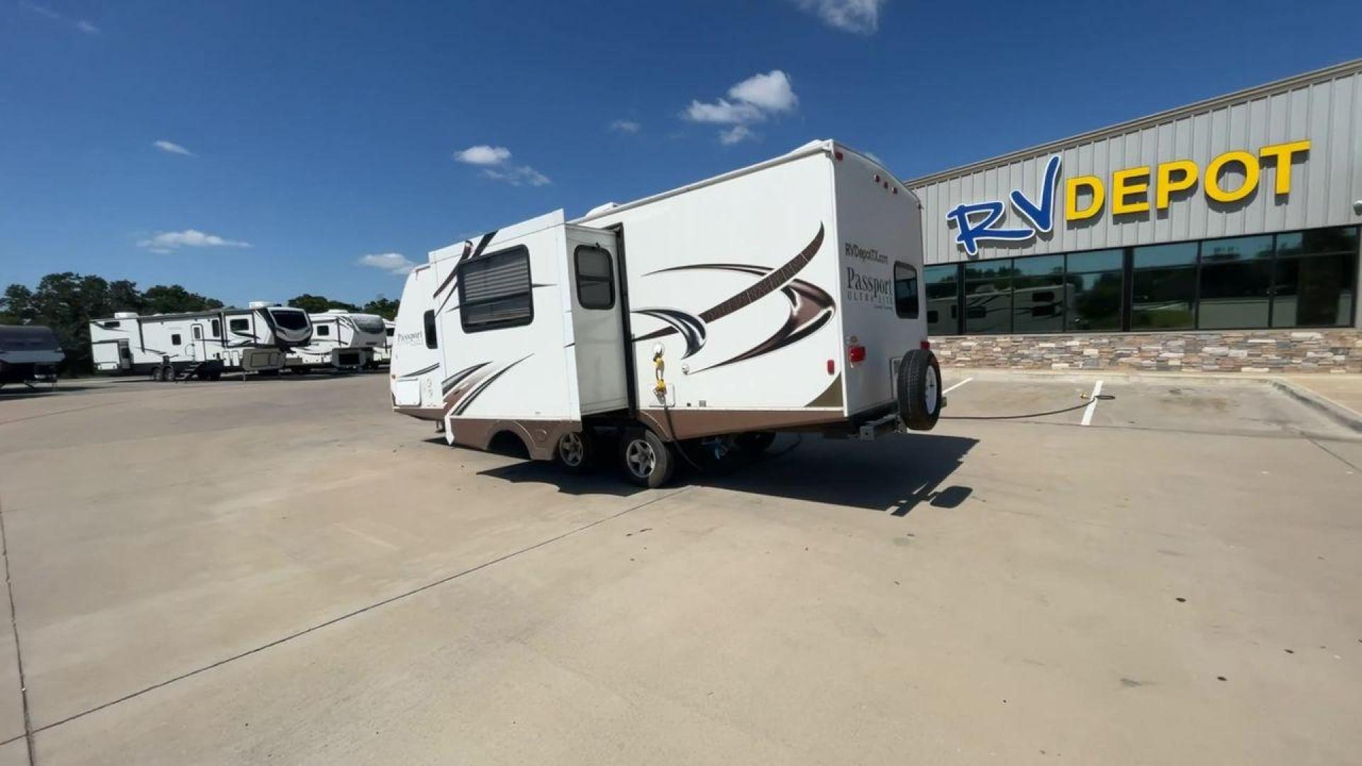 2014 WHITE KEYSTONE PASSPORT 2400BH (4YDT24029ET) , Length: 27.83 ft. | Dry Weight: 4,730 lbs. | Gross Weight: 6,800 lbs. | Slides: 1 transmission, located at 4319 N Main St, Cleburne, TX, 76033, (817) 678-5133, 32.385960, -97.391212 - The 2014 Keystone Passport 2400BH is a dual-axle steel wheel set-up that measures 27.83 ft. in length. It has a dry weight of 4,730 lbs. and a GVWR of 6,800 lbs. It also has a payload capacity of 2,070 lbs. and a hitch weight of 515 lbs. Its exterior is a base color of white with black and brown acc - Photo#7