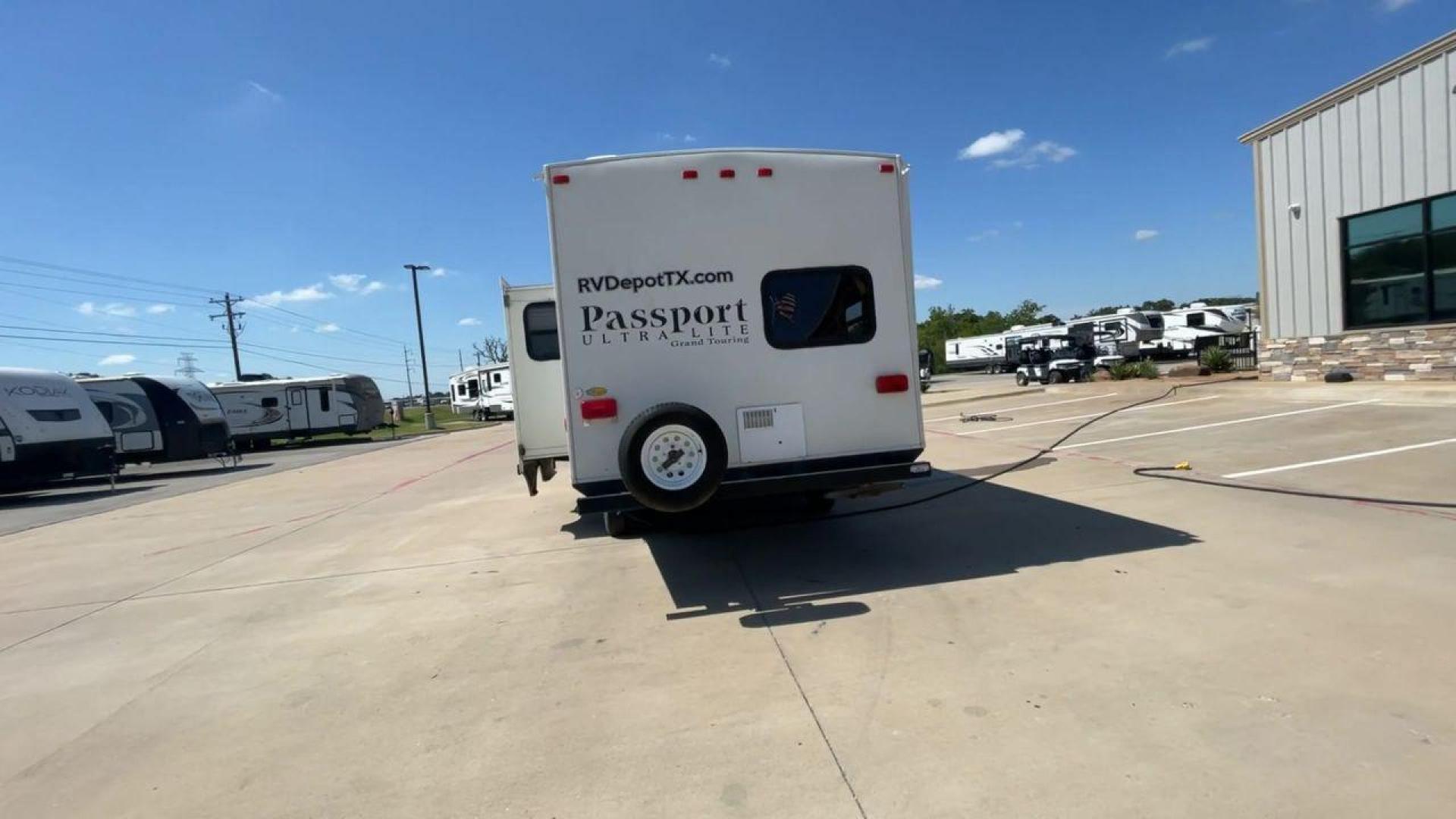 2014 WHITE KEYSTONE PASSPORT 2400BH (4YDT24029ET) , Length: 27.83 ft. | Dry Weight: 4,730 lbs. | Gross Weight: 6,800 lbs. | Slides: 1 transmission, located at 4319 N Main St, Cleburne, TX, 76033, (817) 678-5133, 32.385960, -97.391212 - The 2014 Keystone Passport 2400BH is a dual-axle steel wheel set-up that measures 27.83 ft. in length. It has a dry weight of 4,730 lbs. and a GVWR of 6,800 lbs. It also has a payload capacity of 2,070 lbs. and a hitch weight of 515 lbs. Its exterior is a base color of white with black and brown acc - Photo#8