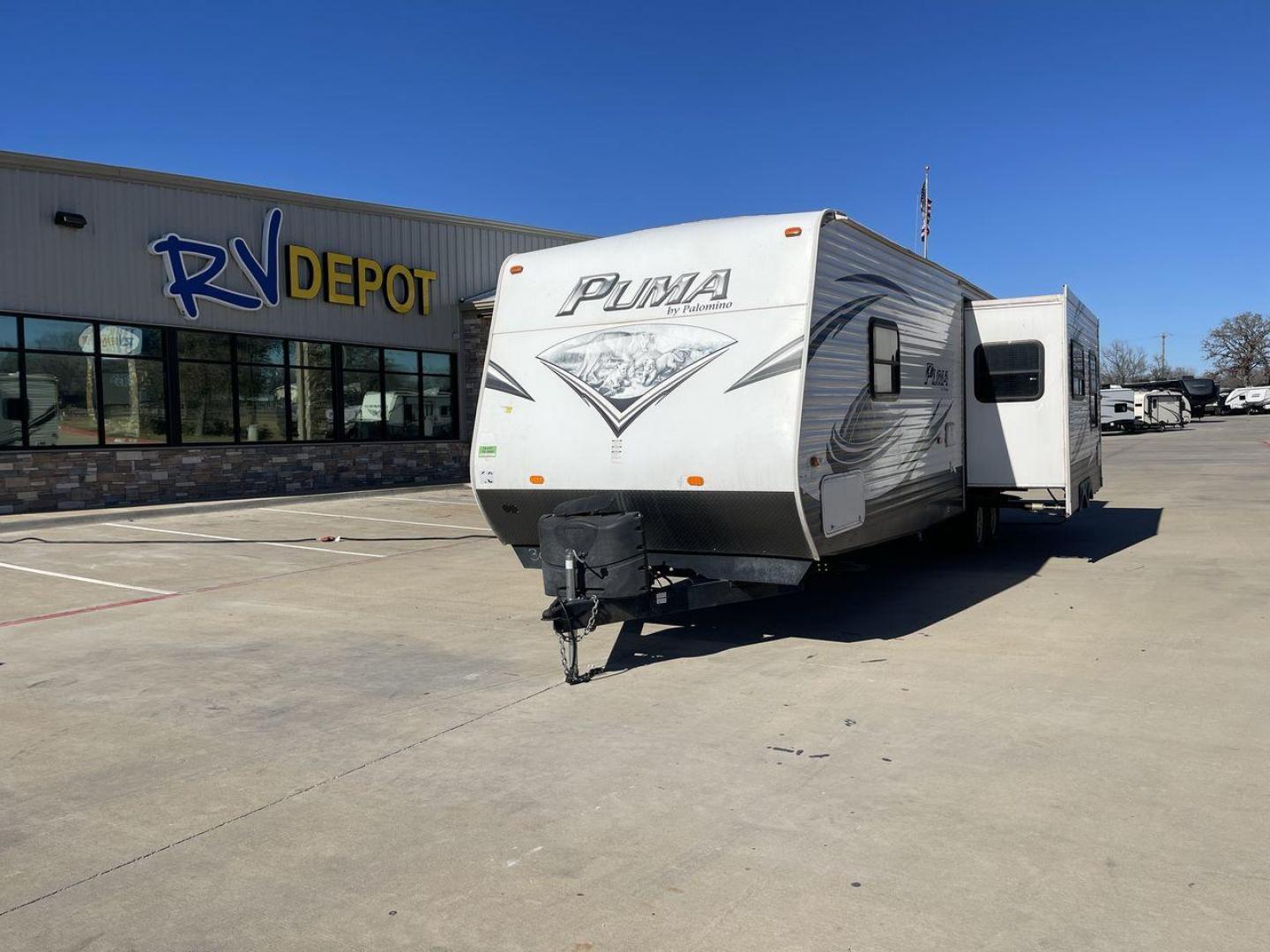 2014 WHITE PUMA 30RKSS (4X4TPUF23EP) , Length: 32.75 ft. | Dry Weight: 6,670 lbs. | Gross Weight: 9,827 lbs. | Slides: 1 transmission, located at 4319 N Main St, Cleburne, TX, 76033, (817) 678-5133, 32.385960, -97.391212 - Looking for a travel trailer that offers comfort, convenience, and style? Look no further than this 2014 PUMA 30RKSS available at RV Depot in Cleburne, TX. With its spacious interior, sleek white exterior, and rear living layout, this travel trailer is perfect for your next adventure. The PUMA 30RK - Photo#0