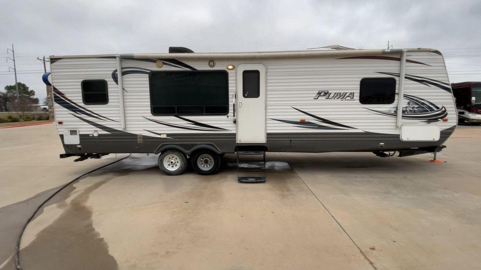 2014 WHITE PUMA 30RKSS (4X4TPUF23EP) , Length: 32.75 ft. | Dry Weight: 6,670 lbs. | Gross Weight: 9,827 lbs. | Slides: 1 transmission, located at 4319 N Main St, Cleburne, TX, 76033, (817) 678-5133, 32.385960, -97.391212 - Looking for a travel trailer that offers comfort, convenience, and style? Look no further than this 2014 PUMA 30RKSS available at RV Depot in Cleburne, TX. With its spacious interior, sleek white exterior, and rear living layout, this travel trailer is perfect for your next adventure. The PUMA 30RK - Photo#2